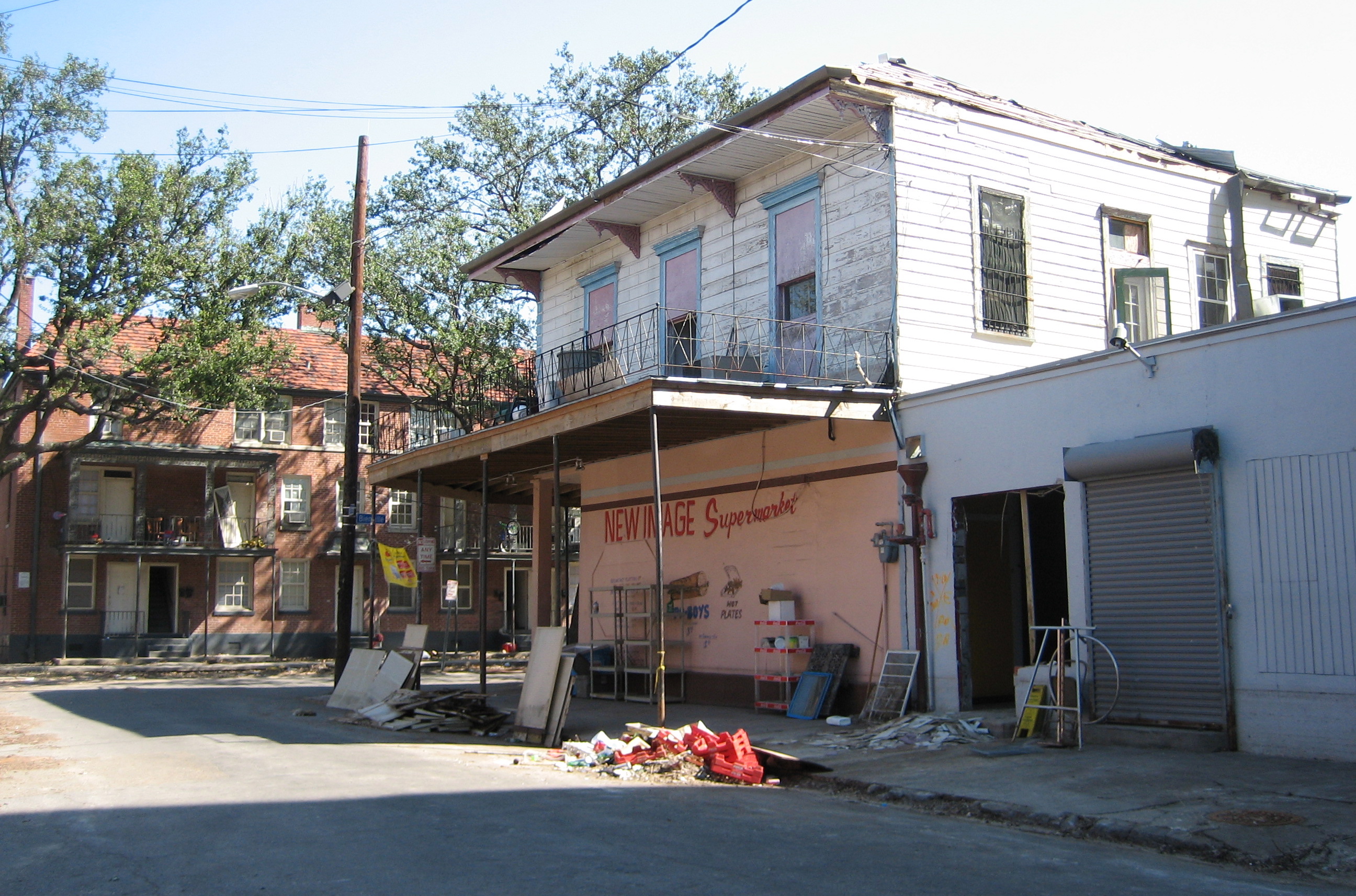 New Orleans after Hurricane Katrina:One of the few surviving buildings from the historic en:Storyville Red Light District.Most recently, New Image Supermarket (which still exists as of January 2021); a century earlier, Frank Early's Saloon.Notice line, especially visible on building at right, left by long-standing level of floodwater at about knee level.