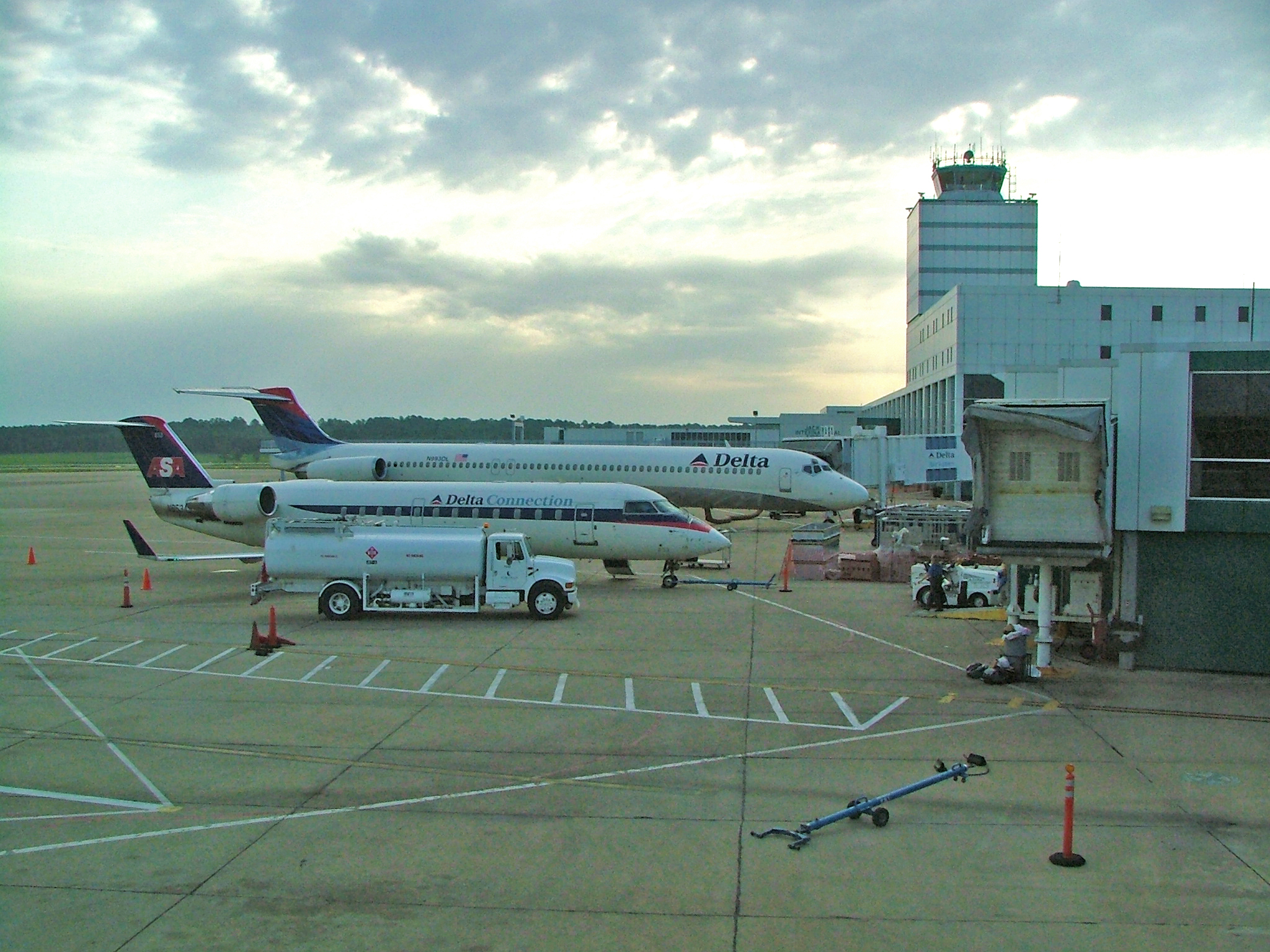 Jackson-Evers International Airport in July 2005. View from the West Concourse looking east across the tarmac. The aircraft in the foreground is a Canadair Regional Jet operated by Atlantic Southeast Airlines. Behind it is a Delta Air Lines McDonnell-Douglas MD-88. Photograph taken 12 July 2005 by Peter Clericuzio, using a Fuji FinePix S5000 digital camera.