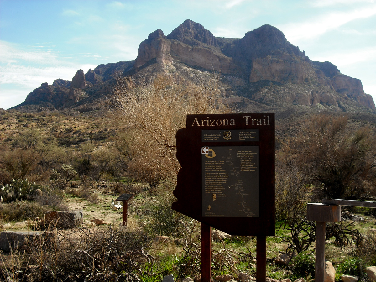 Sign for the Arizona Trail as it passes near Picketpost Mountain (background) in Superior, Arizona.
