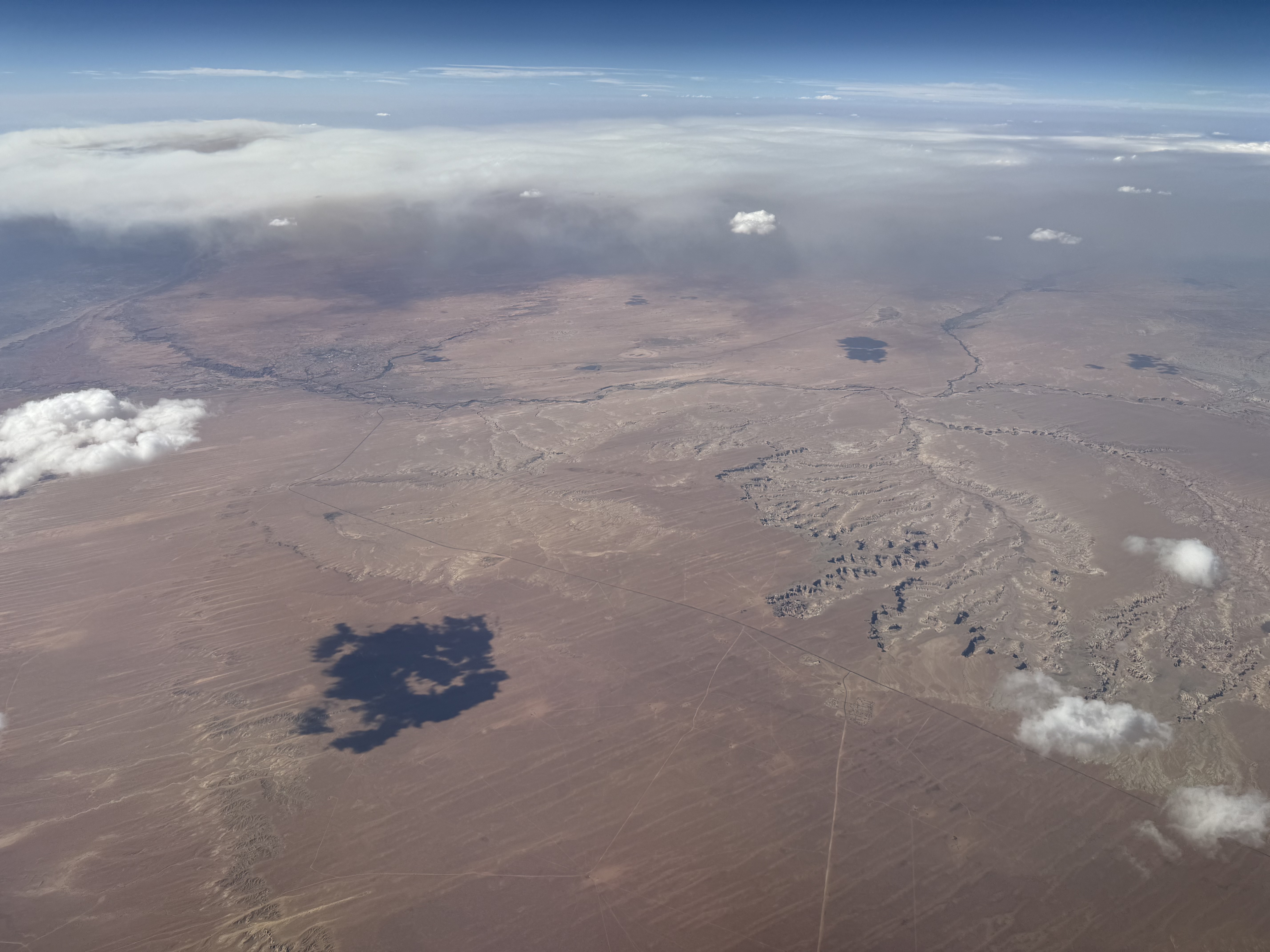 Aerial view of the Navajo Nation (top) and Hopi Indian Reservation (bottom) in Navajo County (right) and Coconino County (left) in Arizona, with the plume from the Dragon Bravo Fire visible (upper left)