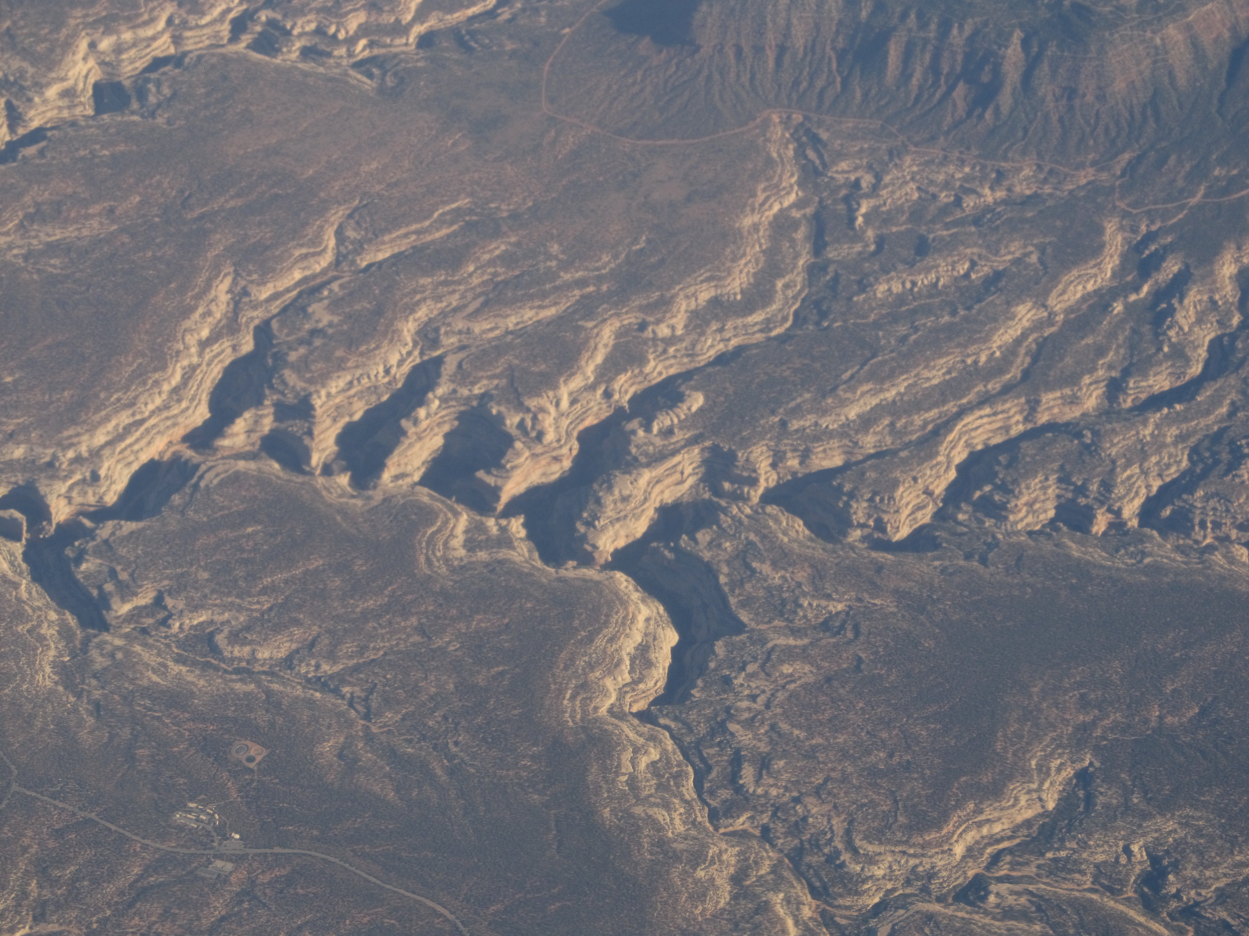 Natural Bridges National Monument is a U.S. National Monument located about 50 miles (80 km) northwest of the Four Corners boundary of southeast Utah, in the western United States, at the junction of White Canyon and Armstrong Canyon, part of the Colorado River drainage. It features the second largest natural bridge in the world,[4] carved from the white Permian sandstone of the Cedar Mesa Formation that gives White Canyon its name.
The three bridges in the park are named Kachina, Owachomo, and Sipapu (the largest), which are all Hopi names. A natural bridge is formed through erosion by water flowing in the stream bed of the canyon. During periods of flash floods, particularly, the stream undercuts the walls of rock that separate the meanders (or "goosenecks") of the stream, until the rock wall within the meander is undercut and the meander is cut off; the new stream bed then flows underneath the bridge. Eventually, as erosion and gravity enlarge the bridge's opening, the bridge collapses under its own weight. There is evidence of at least two collapsed natural bridges within the Monument.
en.wikipedia.org/wiki/Natural_Bridges_National_Monument

en.wikipedia.org/wiki/Wikipedia:Text_of_Creative_Commons_...