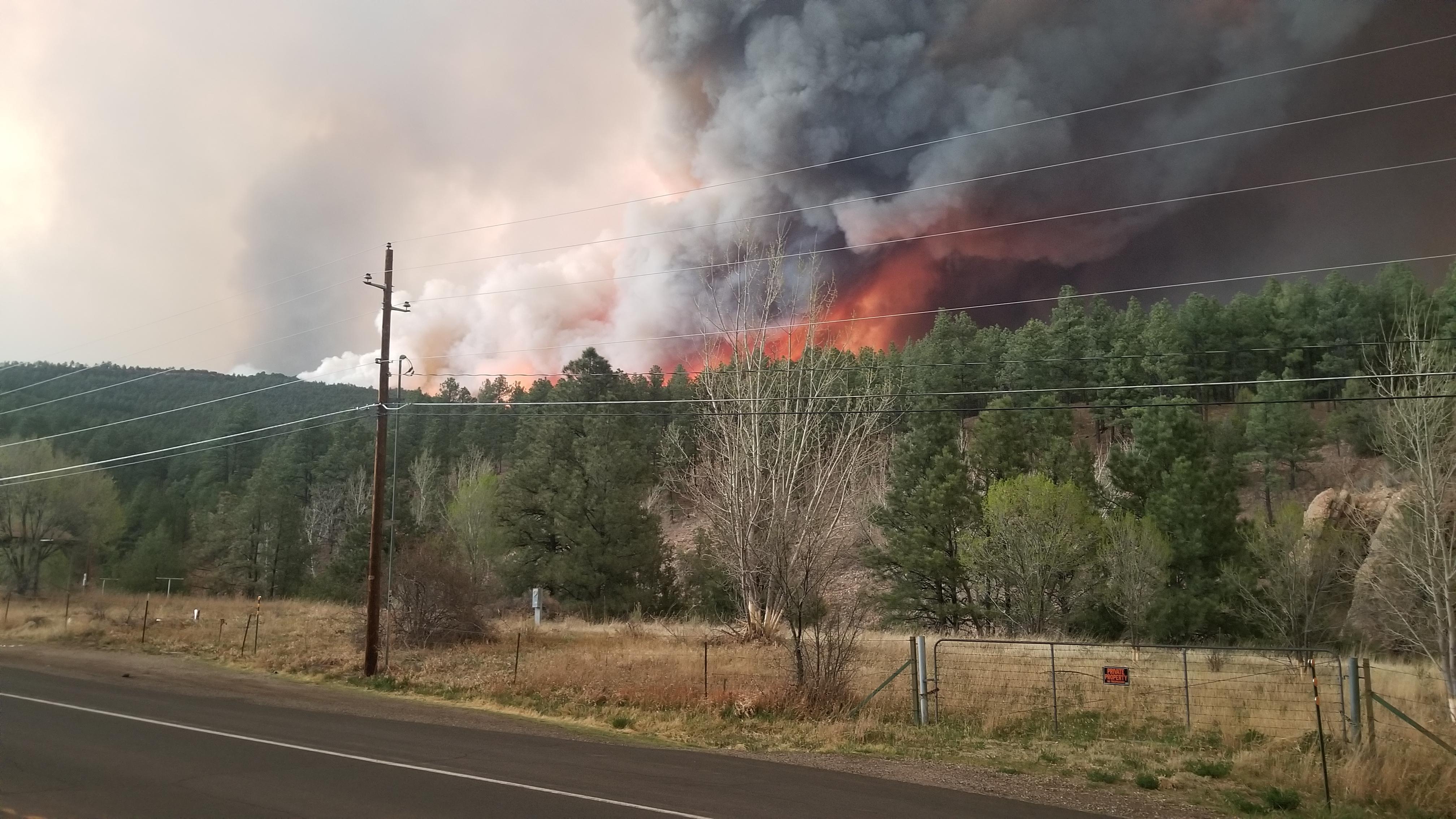 The Calf Canyon/Hermits Peak Fire burns near Highway 518 in New Mexico on April 29, 2022.