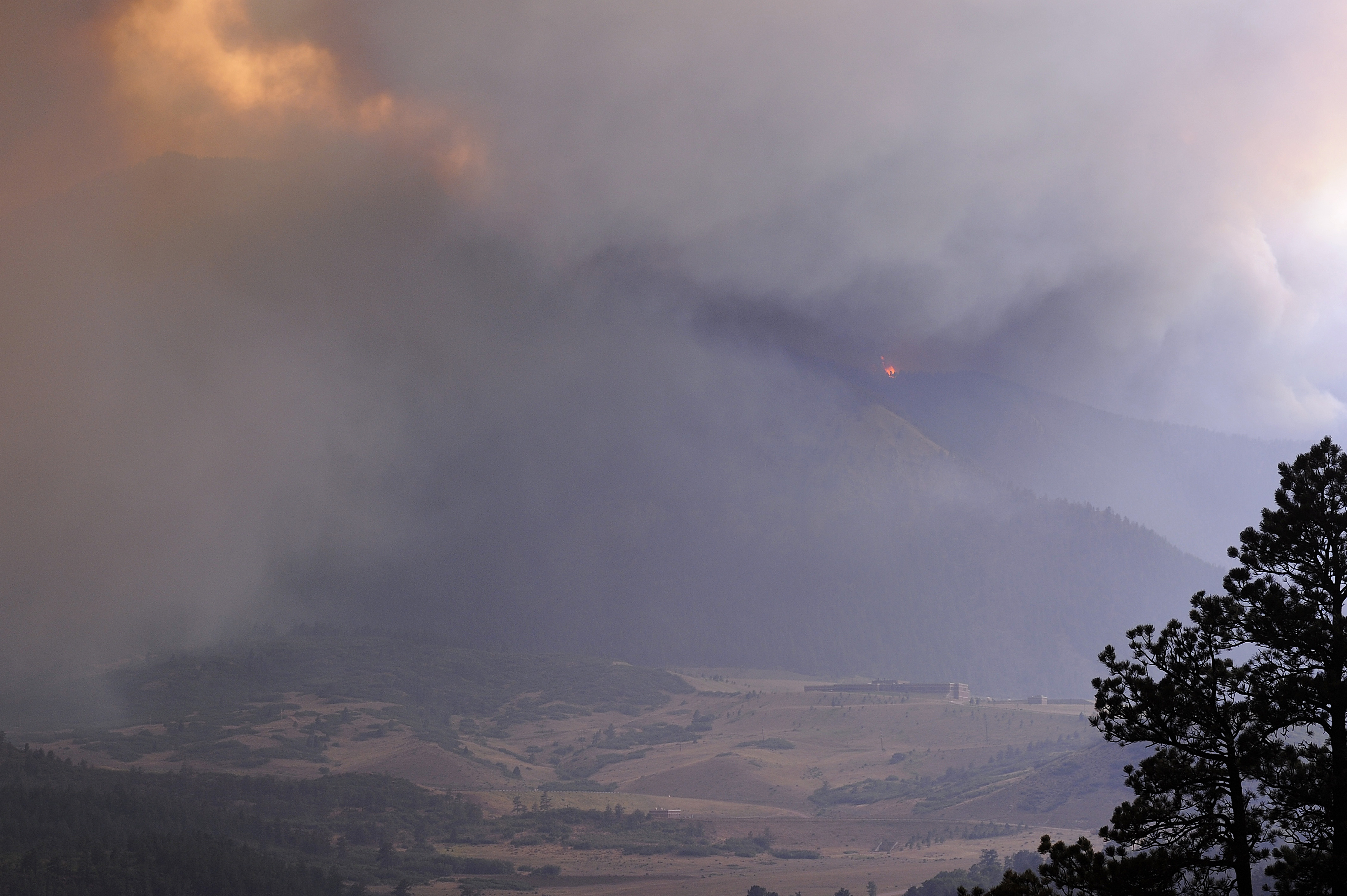 A tremendous smoke cloud builds around the southwest side of U.S. Air Force Academy in Colorado Springs, CO on June 26, 2012. Winds in excess of 65 mph created billowing and rapidly building smoke from the local Waldo Canyon fire.  (U.S. Air Force photo/Mike Kaplan)