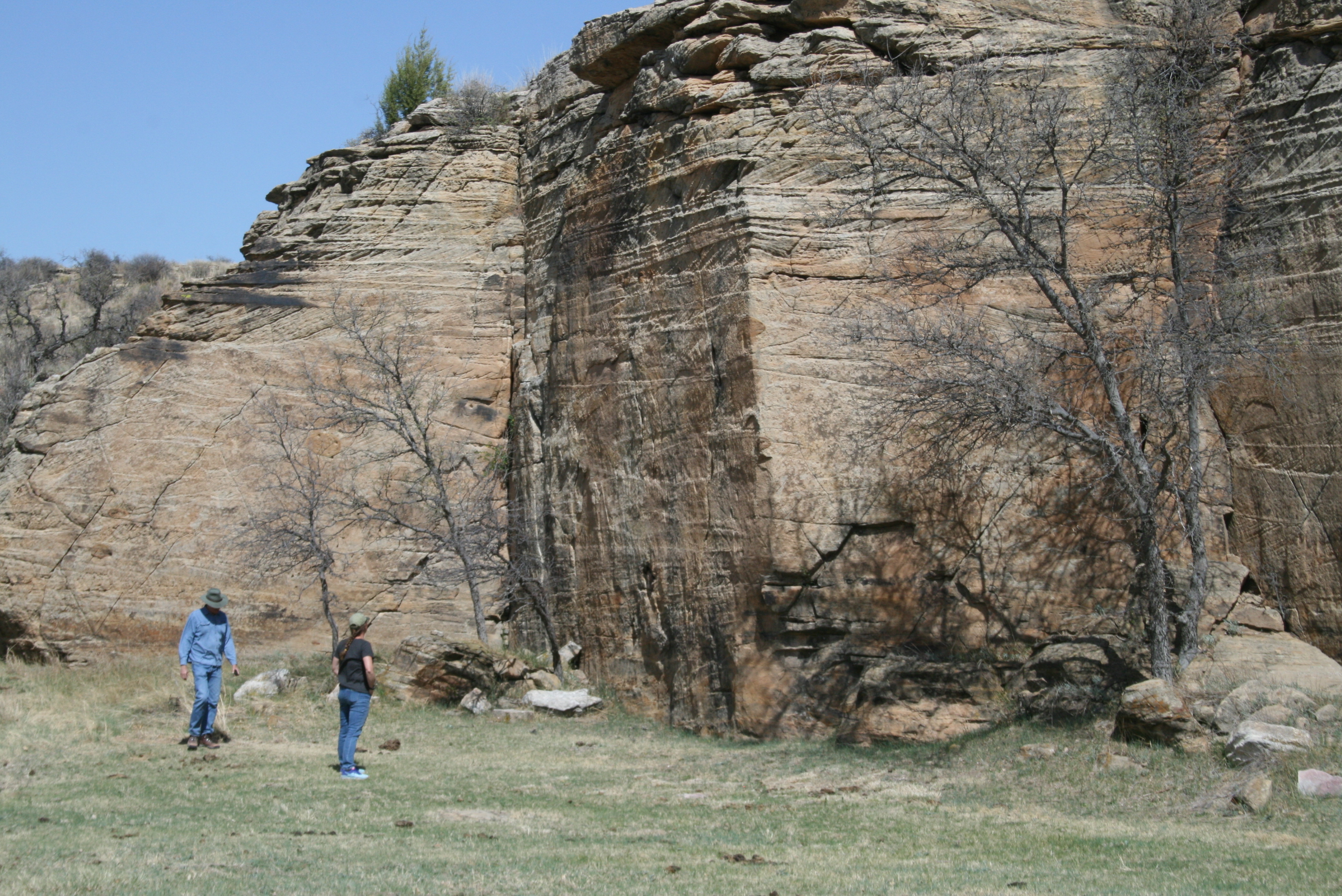 (2) People standing beside Autograph Rock
(2) people looking at Autograph Rock; http://www.santafetrailresearch.com/spacepix/autograph-rock.html; The second Cold Spring is about 7 miles west and 7 miles north of Boise City. Autograph Rock contains the names of many travelers from the 1850s and later.
Keywords: safe; santa fe national historic trail; nht; private; oklahoma; ok; boise city; cimarron county; autograph rock; cultural resources; high potential site; hpsite; historic site; historic area; certified site; natural resources; rock formation; other; people; (SanteFe Trail State)