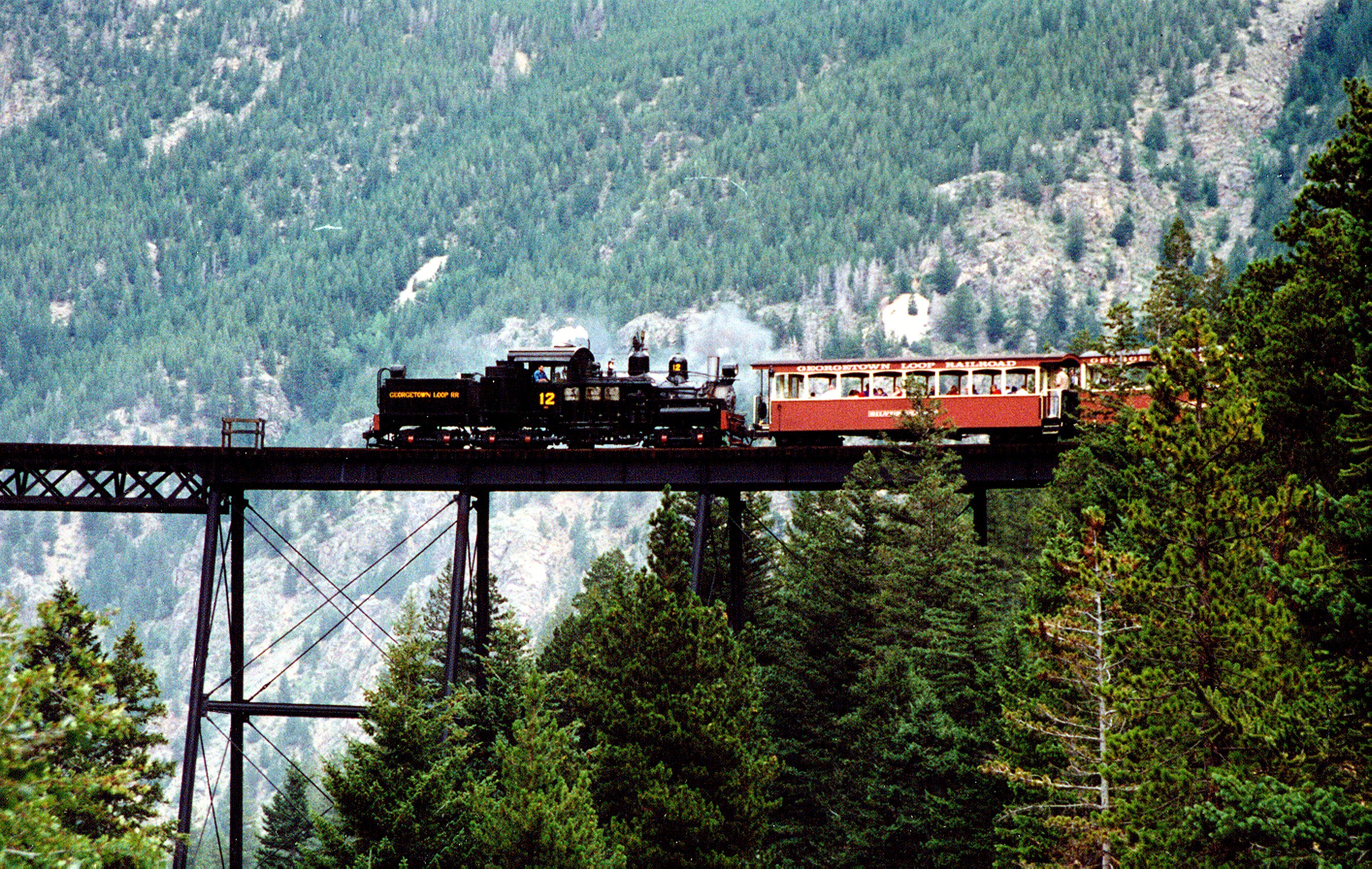 Georgetown Loop Railroad. The locomotive was emitting no smoke in the photo, which indicates that the train was nearing Georgetown after the downhill trip from Silver Plume.  The engine is a rare Shay (geared) type. More info at www.mrollins.com/geared.html.