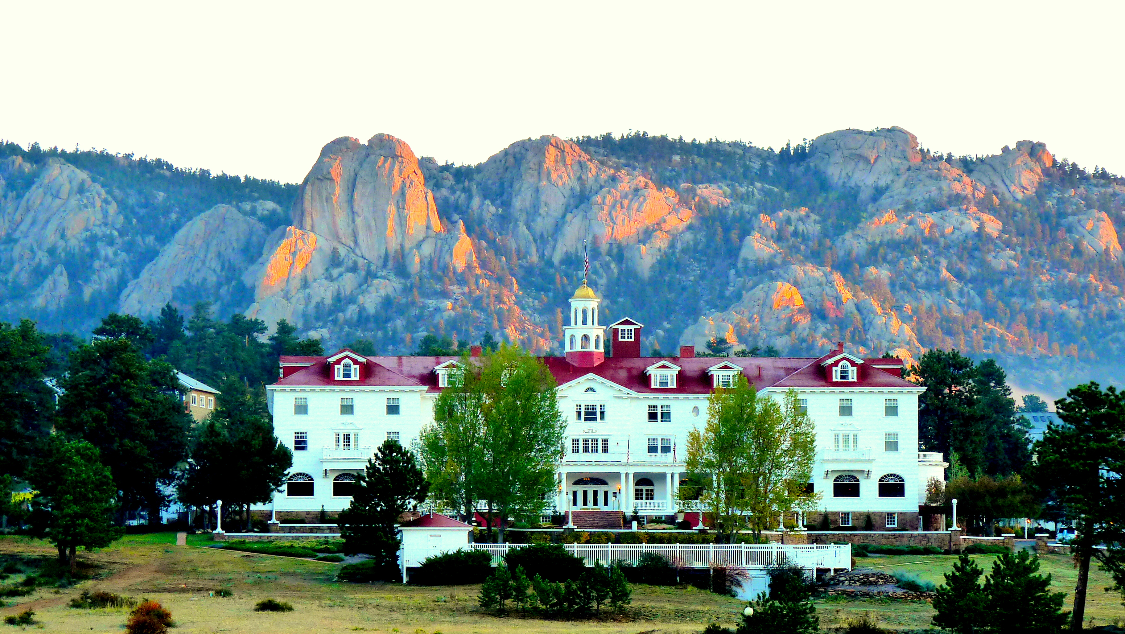 The historic Stanley Hotel in Estes Park, Colorado was established in 1909. Behind The Stanley (as it is known locally) is the "Twin Owls" rock formation.