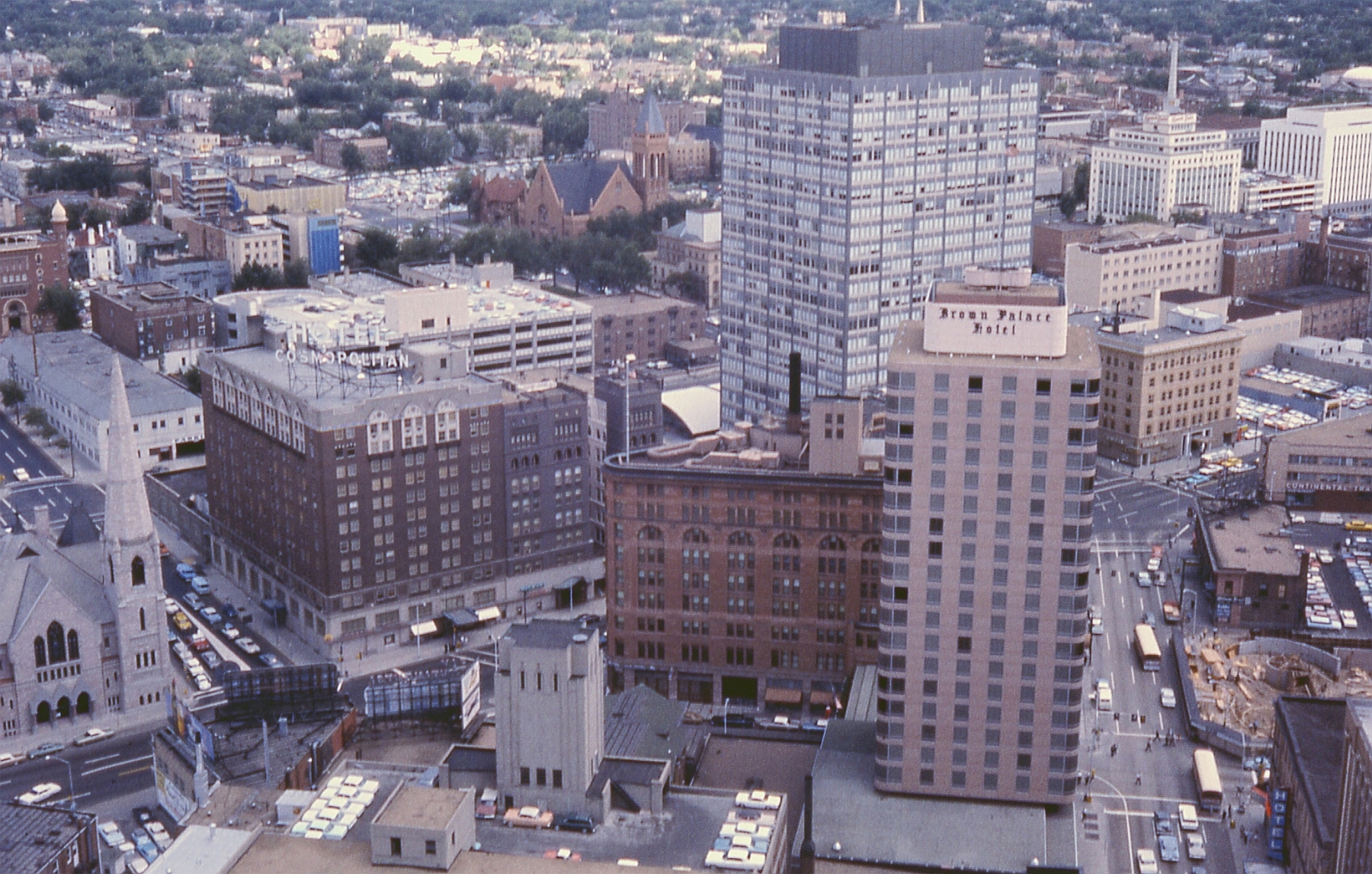 Downtown Denver skyline looking southeast, 1964. Includes Denver's oldest church (Trinity United Methodist - 1820 Broadway), the first building of the Mile High Center complex, the Lincoln Center, the old brownstone part of the Brown Palace Hotel, and the Cosmopolitan Hotel, since demolished. Taken with a 35mm Exakta VX SLR camera and Ektachrome color slide film.