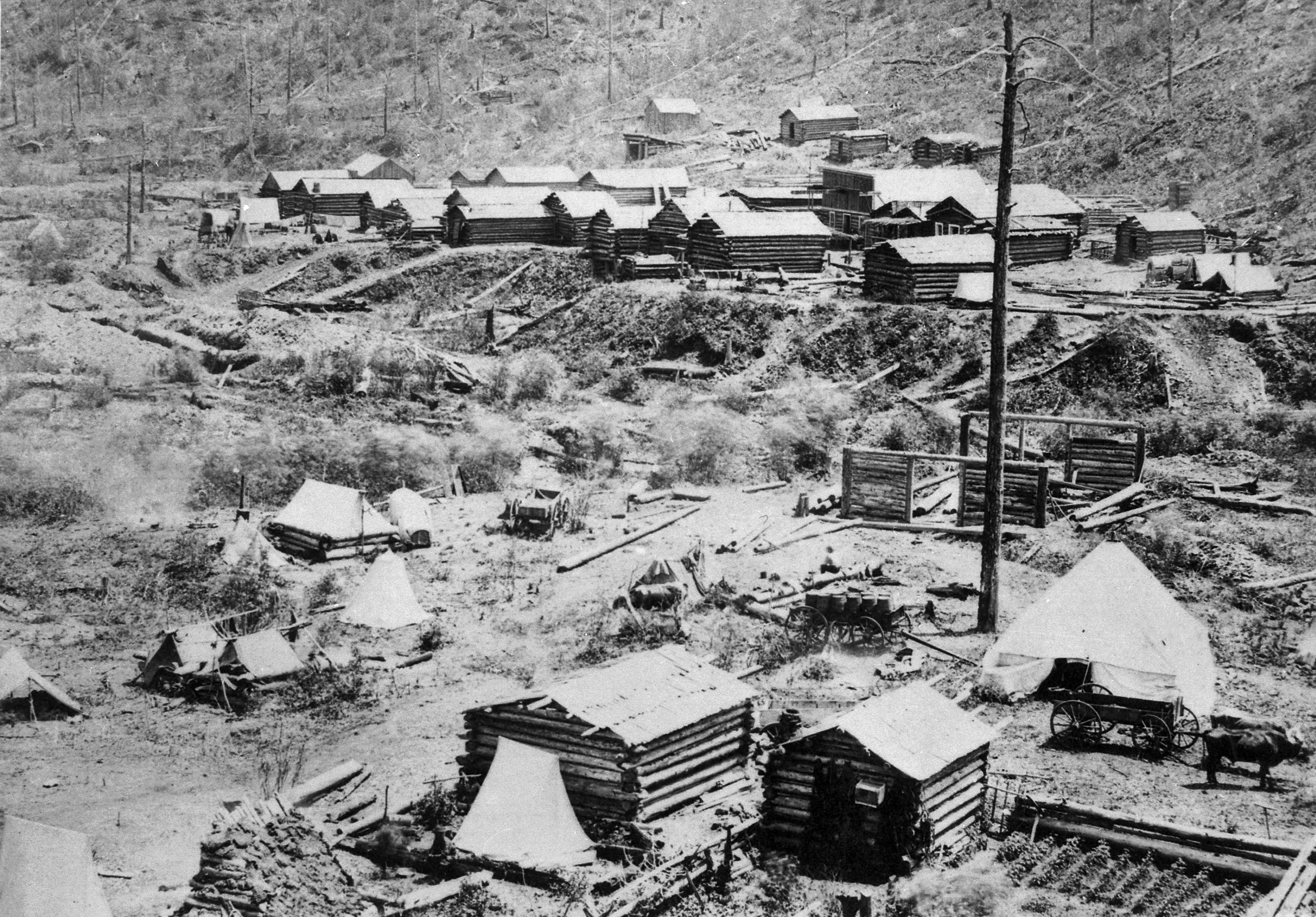"Gayville in Deadwood Gulch, Black Hills (Dak. Terr.), 1876." Log cabins under construction at the foot of a hillside - NARA - 531114.jpg