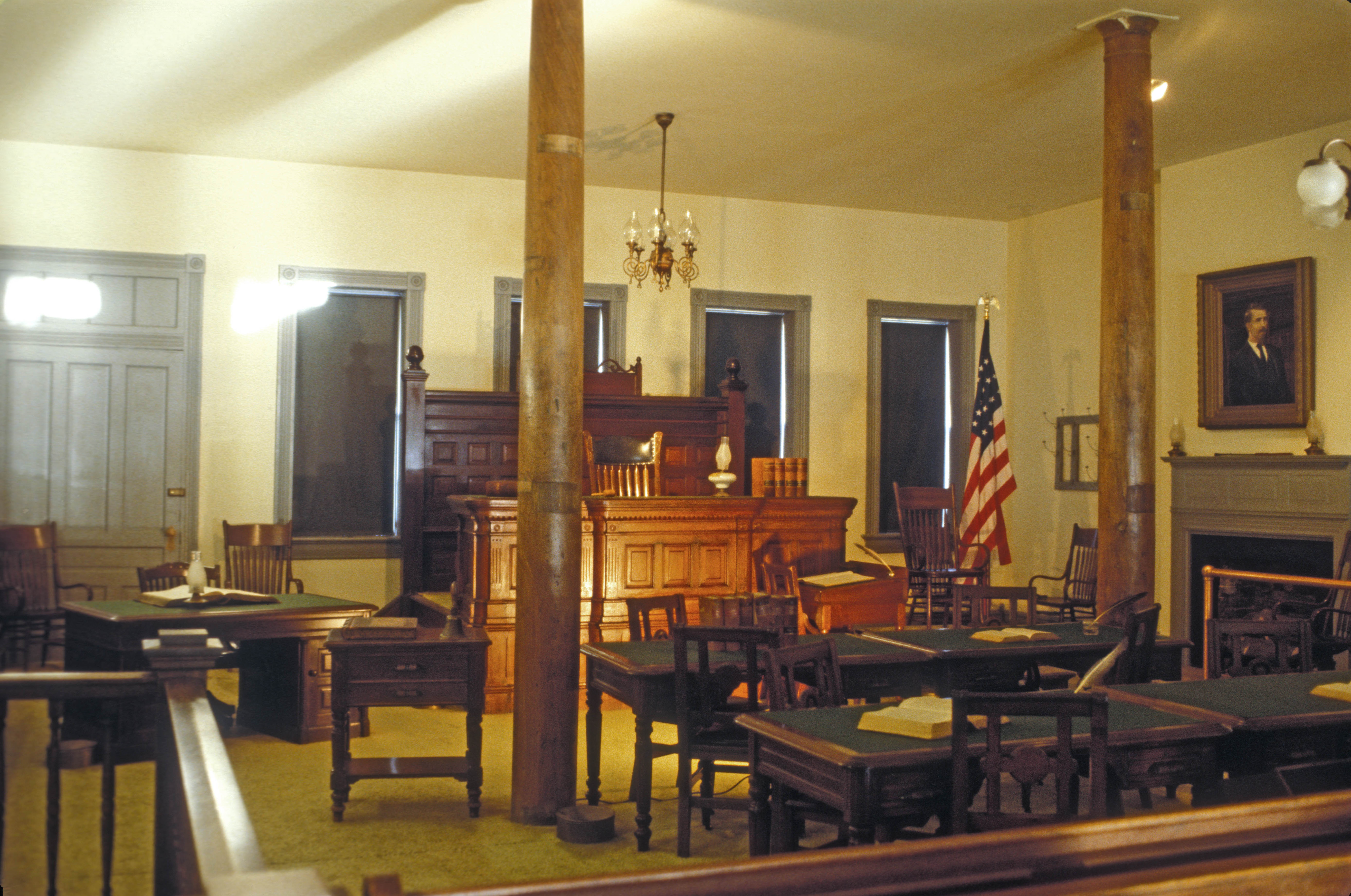 Judge Isaac Parker, the "Hanging Judge" HELD COURT HERE FOR 21 YEARS. HE WAS RESPONSIBLE FOR THE WESTERN HALF OF ARKANSAS AND THE INDIAN TERRITORY OF PRESENT-DAY OKLAHOMA. HE HELD 13,000 TRIALS IN THIS ROOM RESULTING IN CONVICTIONS OF 9,000. HE SENTENCED 160 TO DEATH BUT ONLY 79 WERE HANGED. NO APPEAL WAS POSSIBLE FOR THE  FIRST 14 YEARS. HE BROUGHT LAW AND  ORDER TO THE LAWLESS INDIAN TERRITORY. 
THIS COURTROOM IS INSIDE THE BARRACKS BUILDING OF THE FORT SMITH NATIONAL HISTORIC SITE.