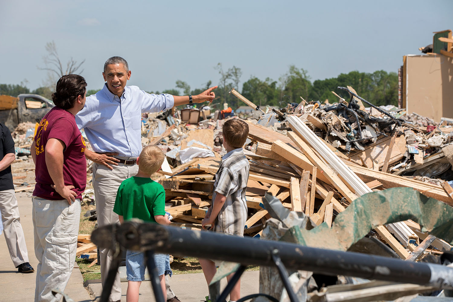 President Barack Obama talks with Daniel Smith and his sons Garrison Dority and Gabriel Dority, right, as he tours the wreckage of a tornado-damaged neighborhood in Vilonia, Ark., May 7, 2014. (Official White House Photo by Pete Souza)