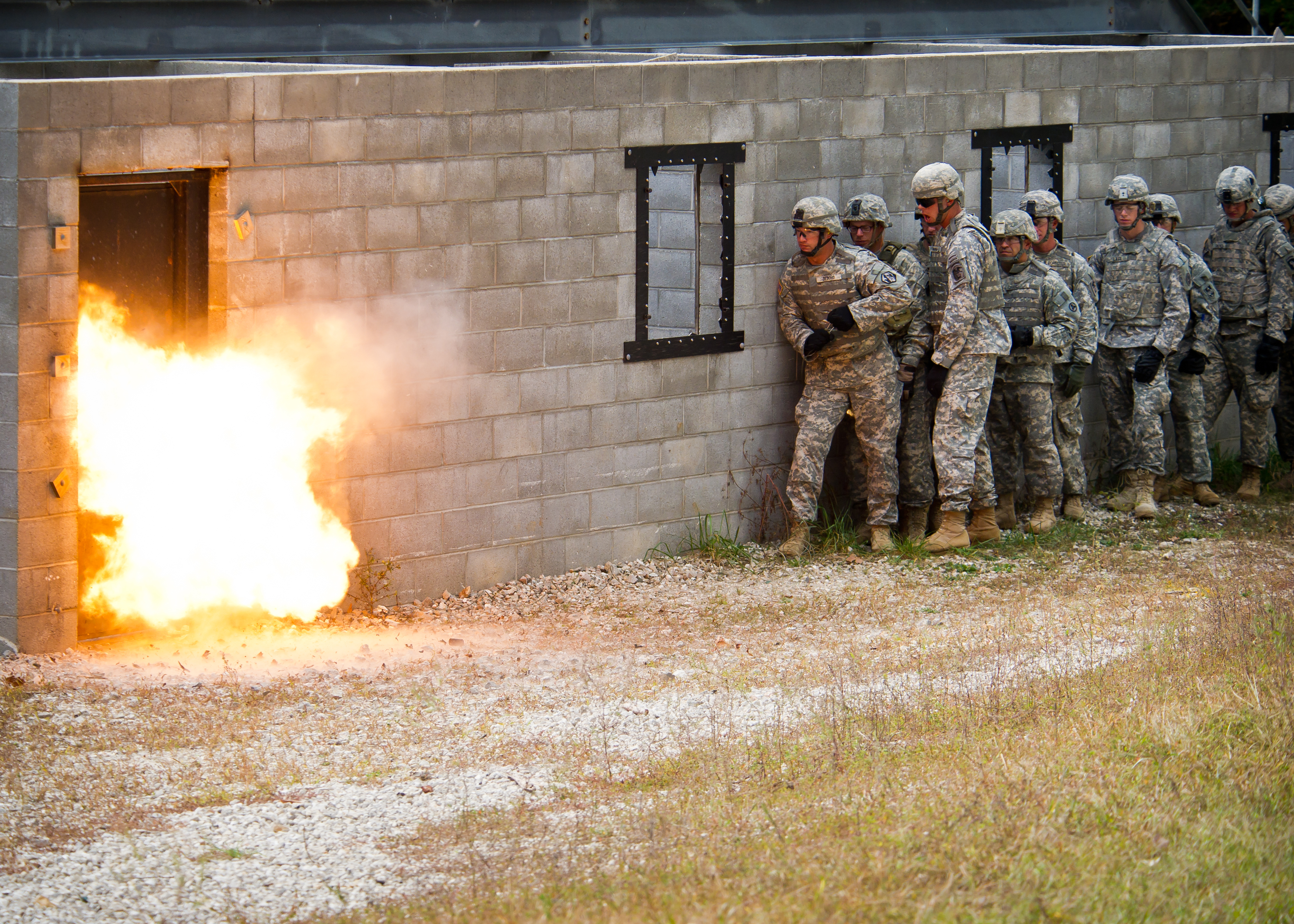 U.S. Soldiers stand back from a fire during military operation in urban terrain and breaching sapper training at Ft. Leonard Wood, Mo., Oct. 11, 2011. (DoD photo by Michael N. Curtis, U.S. Army/Released)