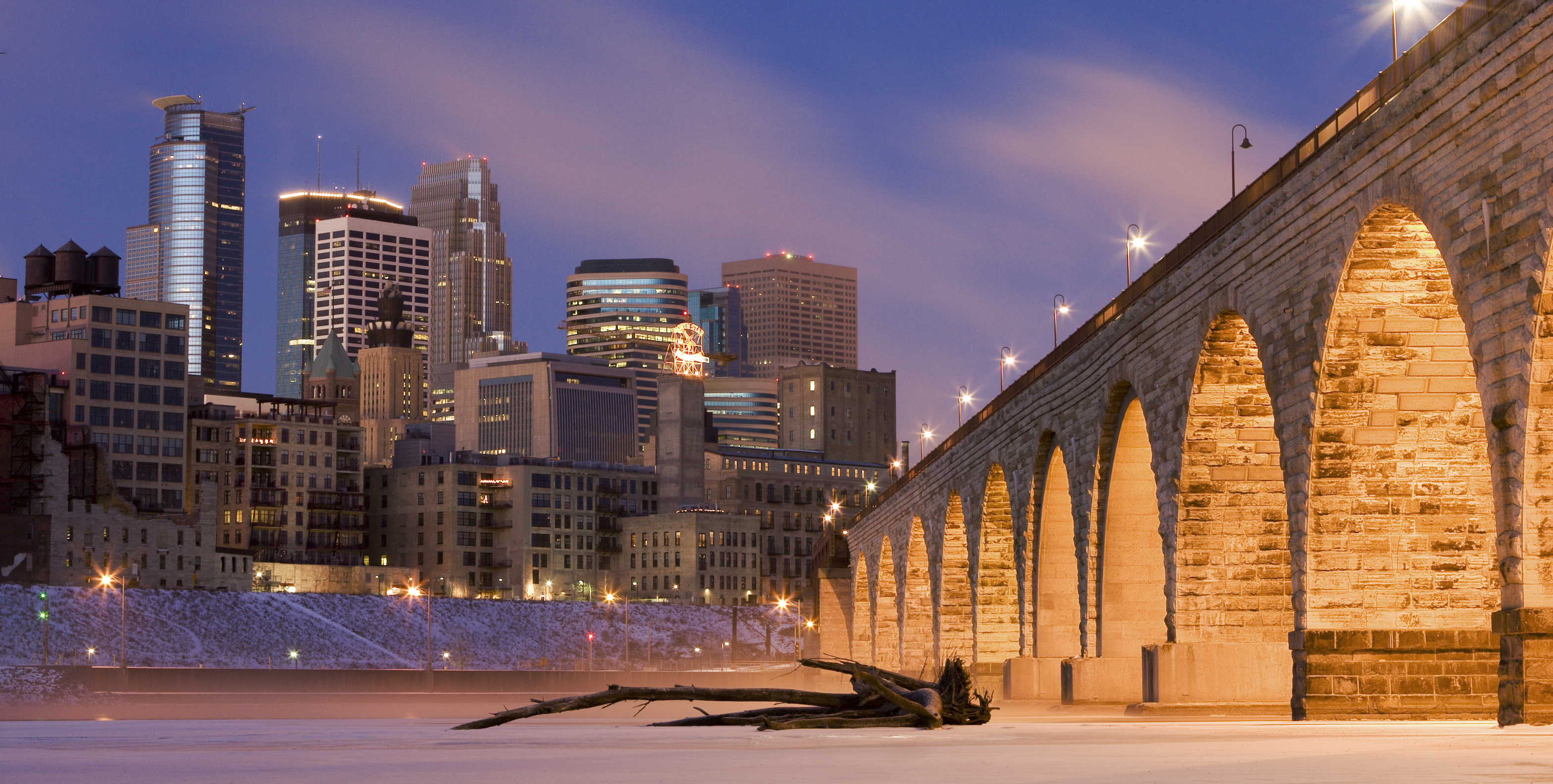 Downtown Minneapolis from across the Mississippi River. At right, the Stone Arch Bridge.