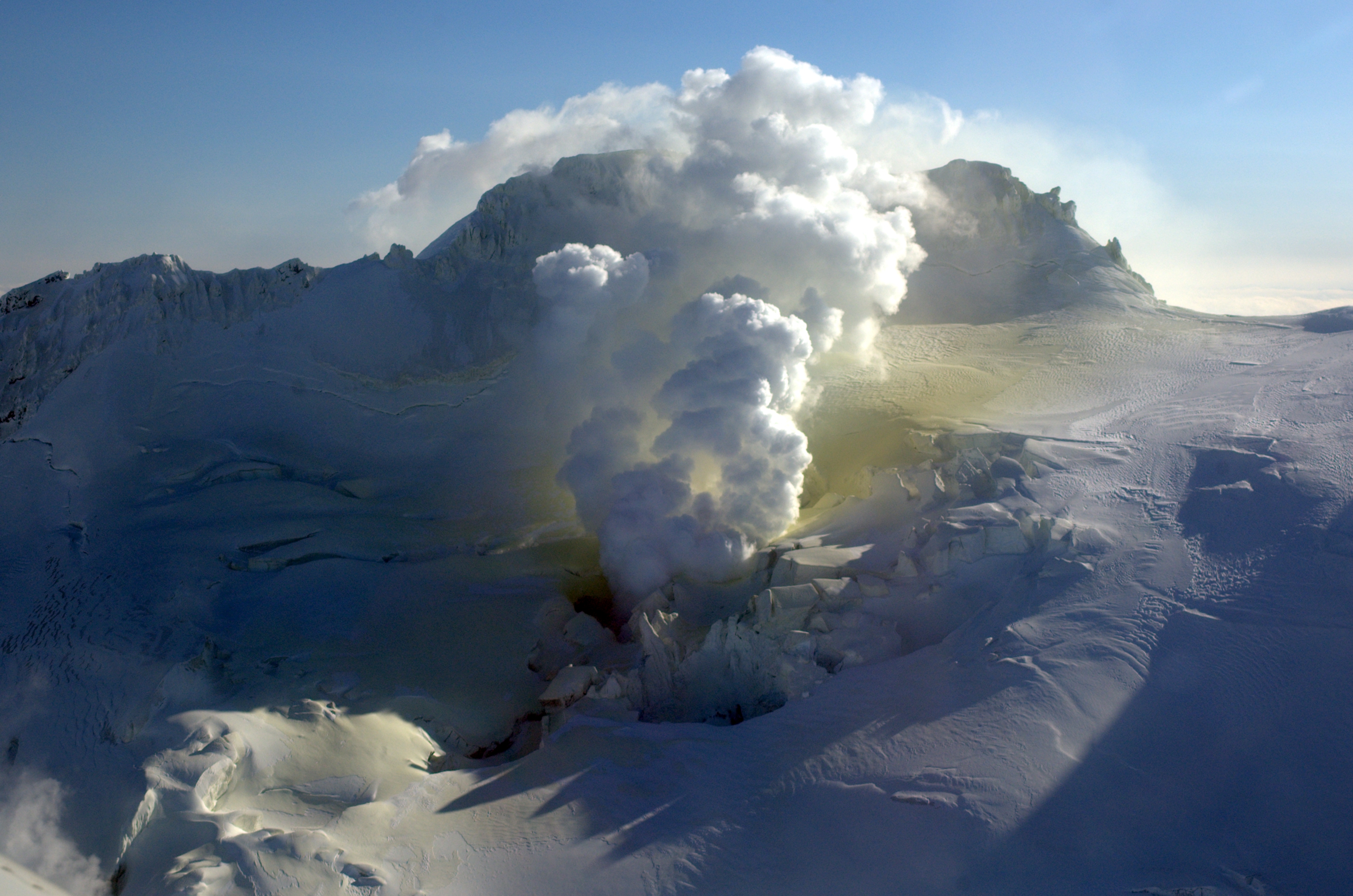 Fumarole on NW side of Fourpeaked. Yellow staining on snow is result of sulfur emission from the vent.