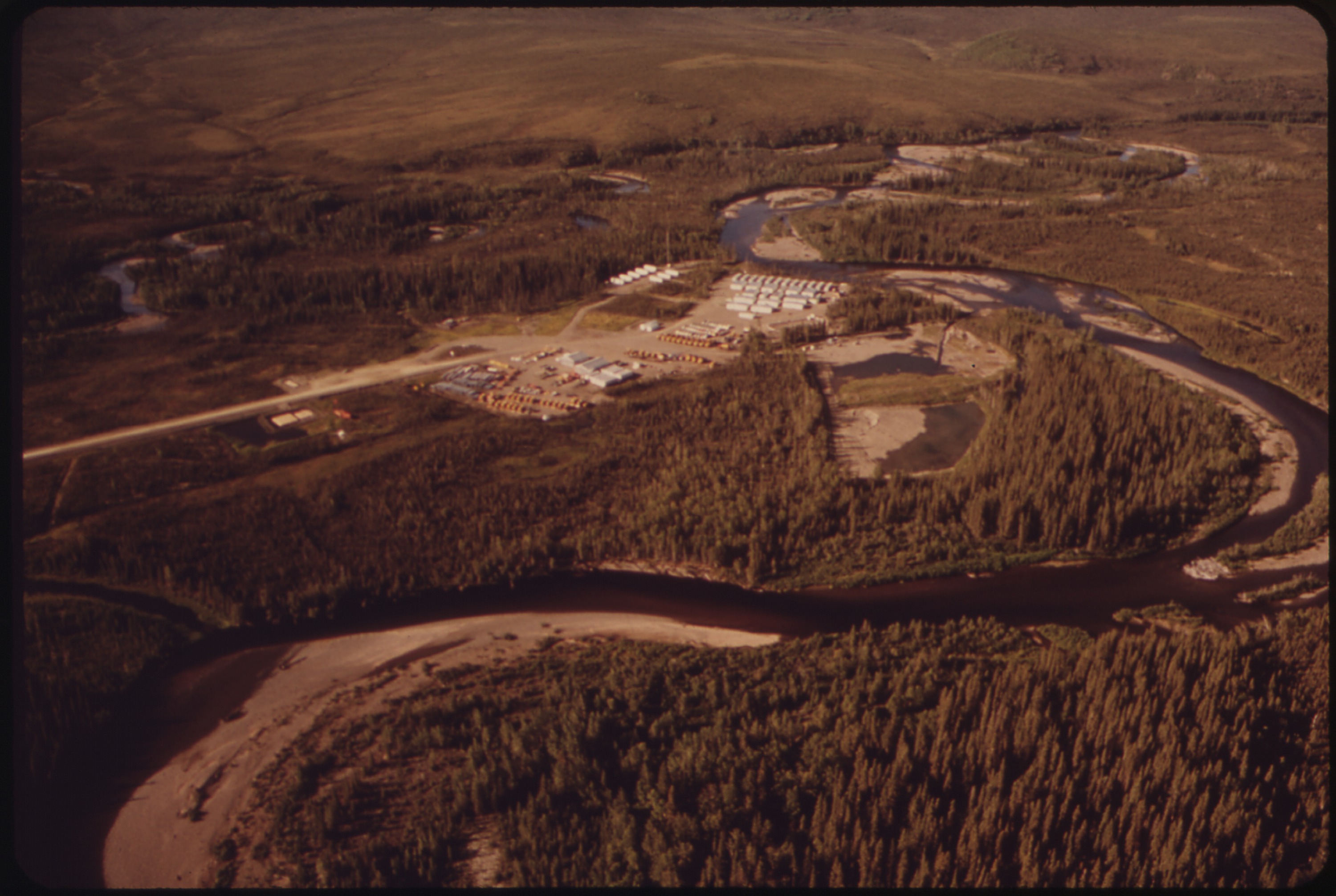PROSPECT CREEK CAMP. VIEW SOUTHWEST ALONG PROSPECT CREEK TO CAMP - NARA - 550534.jpg