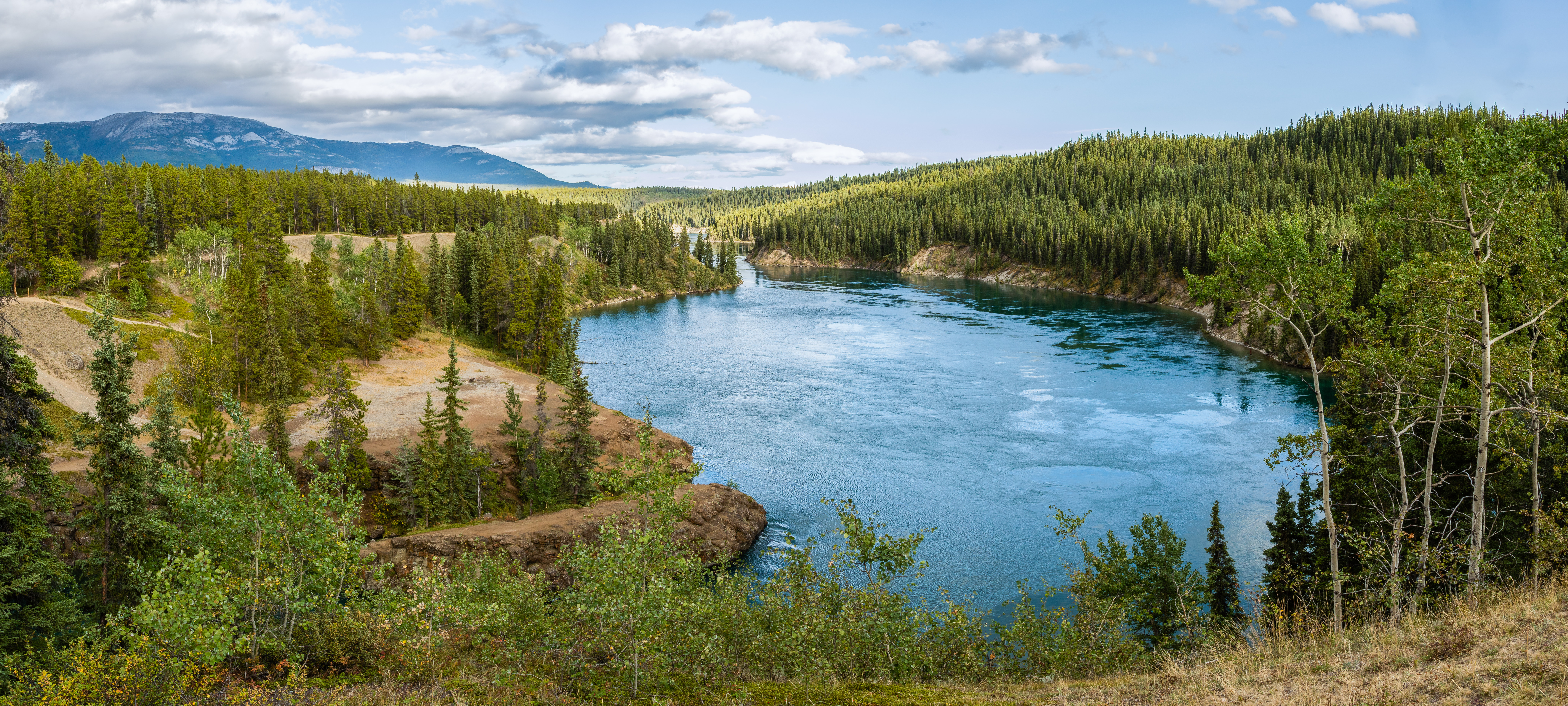 View of the Yukon River at Schwatka Lake and the entry to Miles Canyon, not far from Whitehorse, Yukon, Canada. The Miles Canyon is a featured location for its volcanic basalt formations.