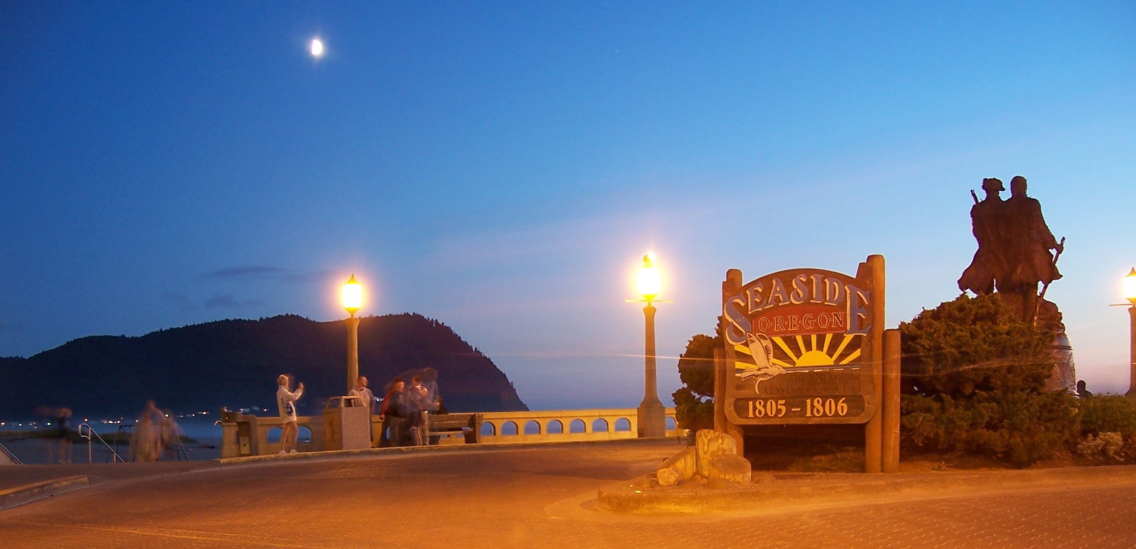 Seaside, Oregon, after sunset.  2 seconds exposure.  An SUV drove round the statuary during exposure (most probably speeding :-))