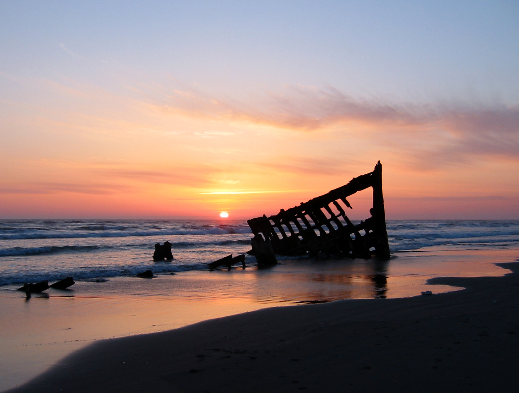 The wreck of the Peter Iredale in the Fort Stevens State Park, Oregon, USA, at sunset. Ran aground in 1906.