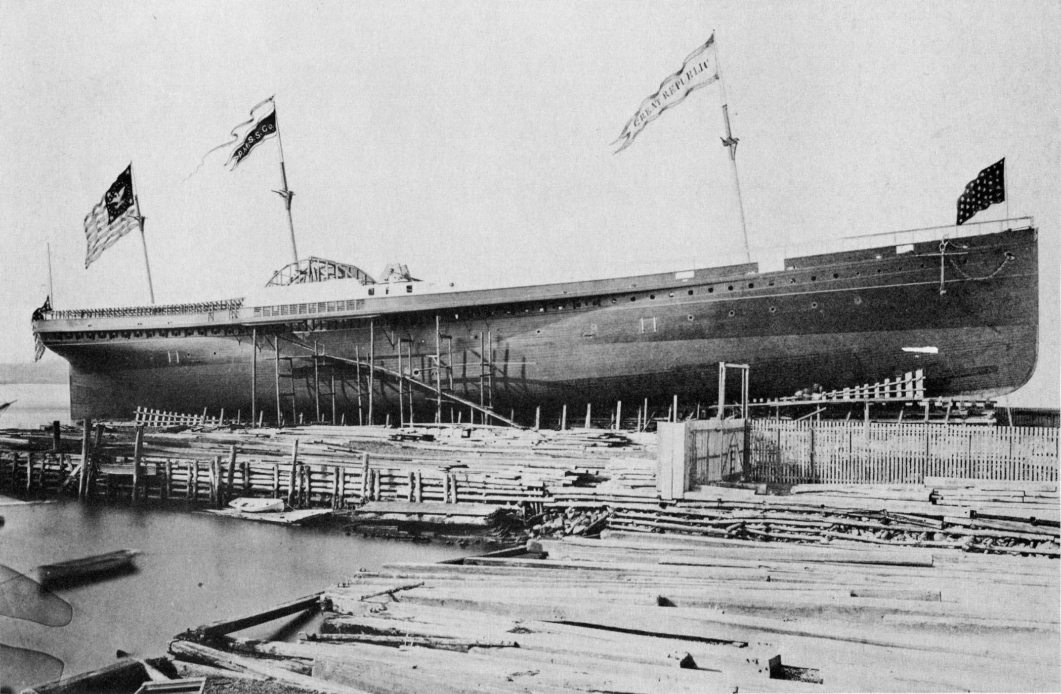SS Great Republic under construction at the yard of Henry Steers, New York, 1866. The flags and pennants seen flying from the ship were hand-painted onto the original photograph.