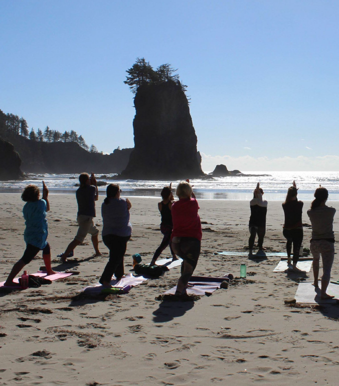 w:Yoga participants practice on the shore of the w:Olympic Coast National Marine Sanctuary.