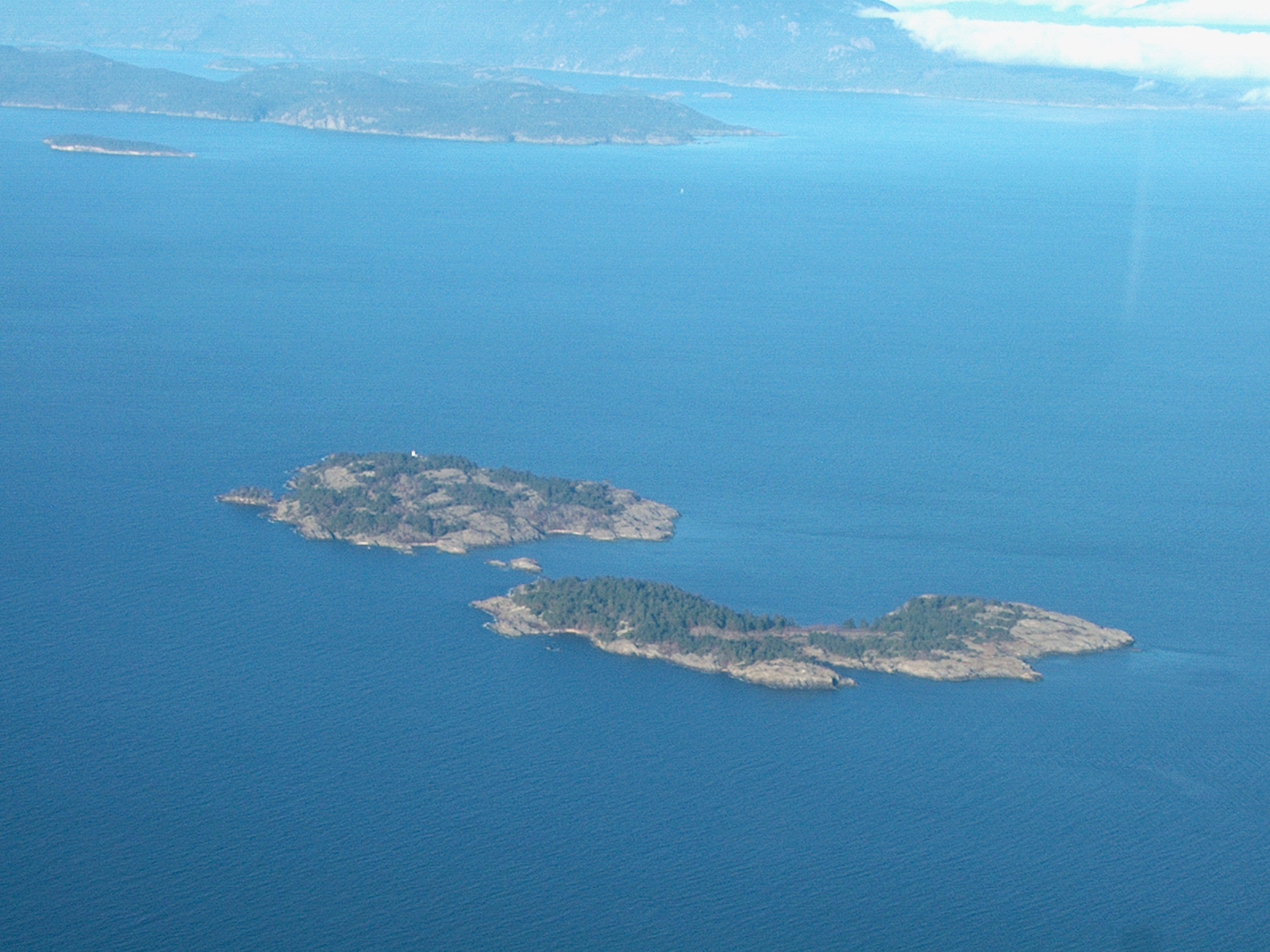 Aerial photograph I took myself of Ballenas Islands in the Strait of Georgia. Ballenas Light is on the top Island of the pair in the foreground.  You can then see Sangster, then Lasqueti and then Texada Islands in the background.  These islands are in the Straits of Georgia between Vancouver Island and mainland British Columbia, Canada.  This photo is taken facing North.