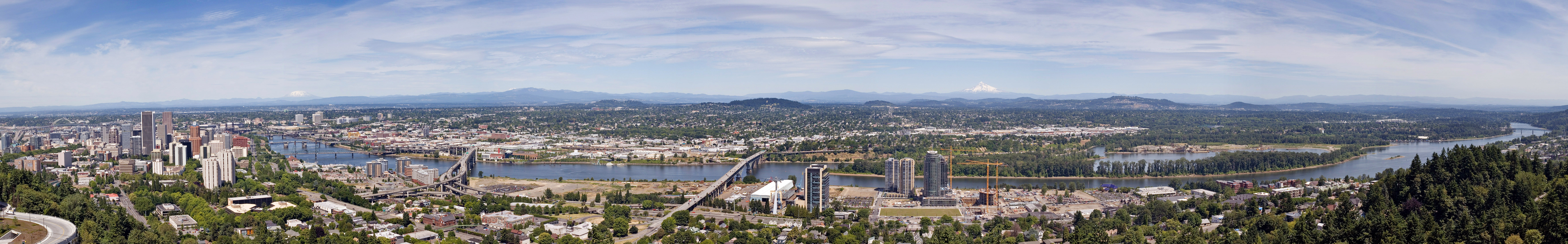 The Willamette River as it passes through downtown Portland, Oregon.  This image is a stitch made from 10 photographs.  The bridges, from right to left, are the Sellwood, Ross Island, Marquam, Hawthorne, Morrison, Burnside, Steel (the black bridge that is partially obscured), Fremont (the arch bridge at far left).  The mountains, from right to left, are Mount Hood, Mount Adams (only the tip is visible) and Mount Saint Helens.