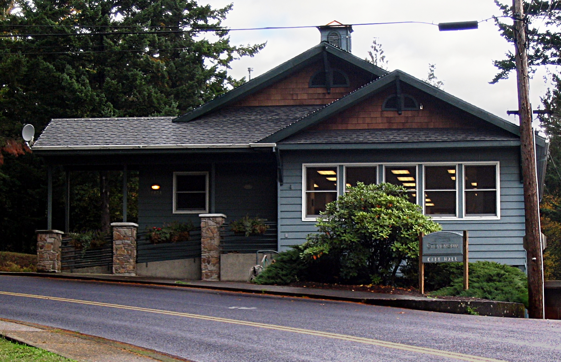 Image of city hall building of the town of Stevenson, Washington, USA. Visible plaque reads "Stevenson CITY HALL". Plaque on side reads "EST. 1906".