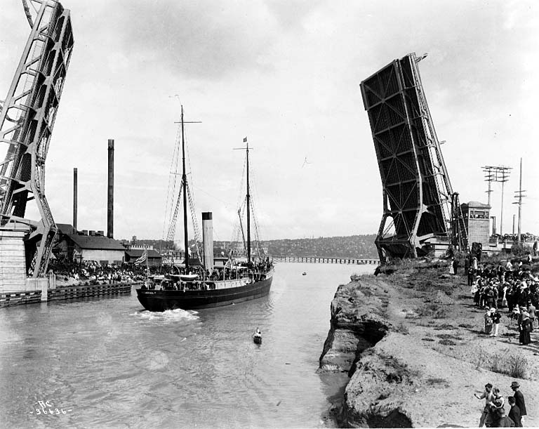 Fremont Bridge at the opening of the Lake Washington Ship Canal, July 4, 1917. Old Stone Way Bridge in the background.