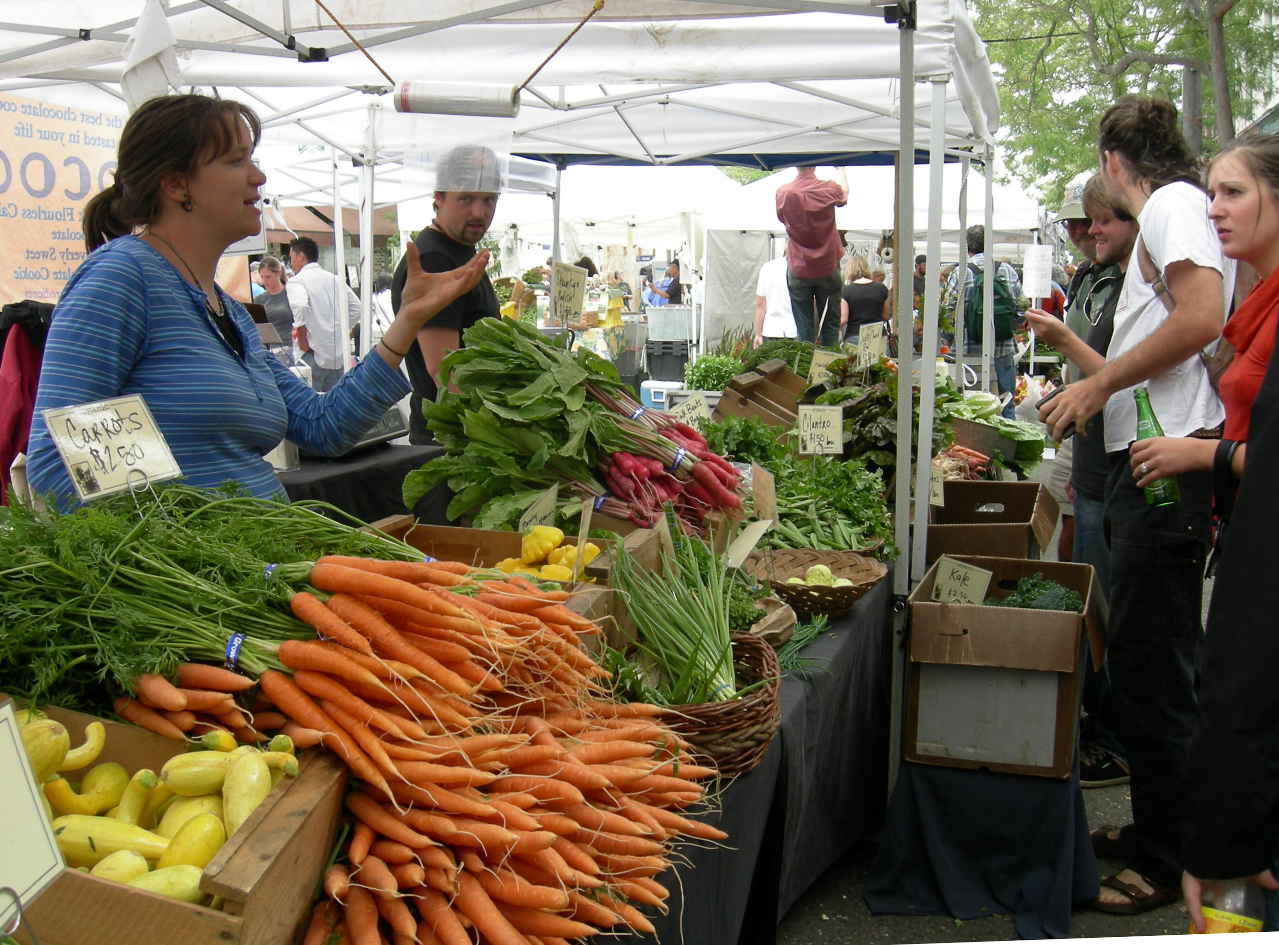 Carrots and other vegetables for sale at Ballard Sunday Farmers' Market, Ballard Avenue (historic district), Ballard, Seattle, Washington.