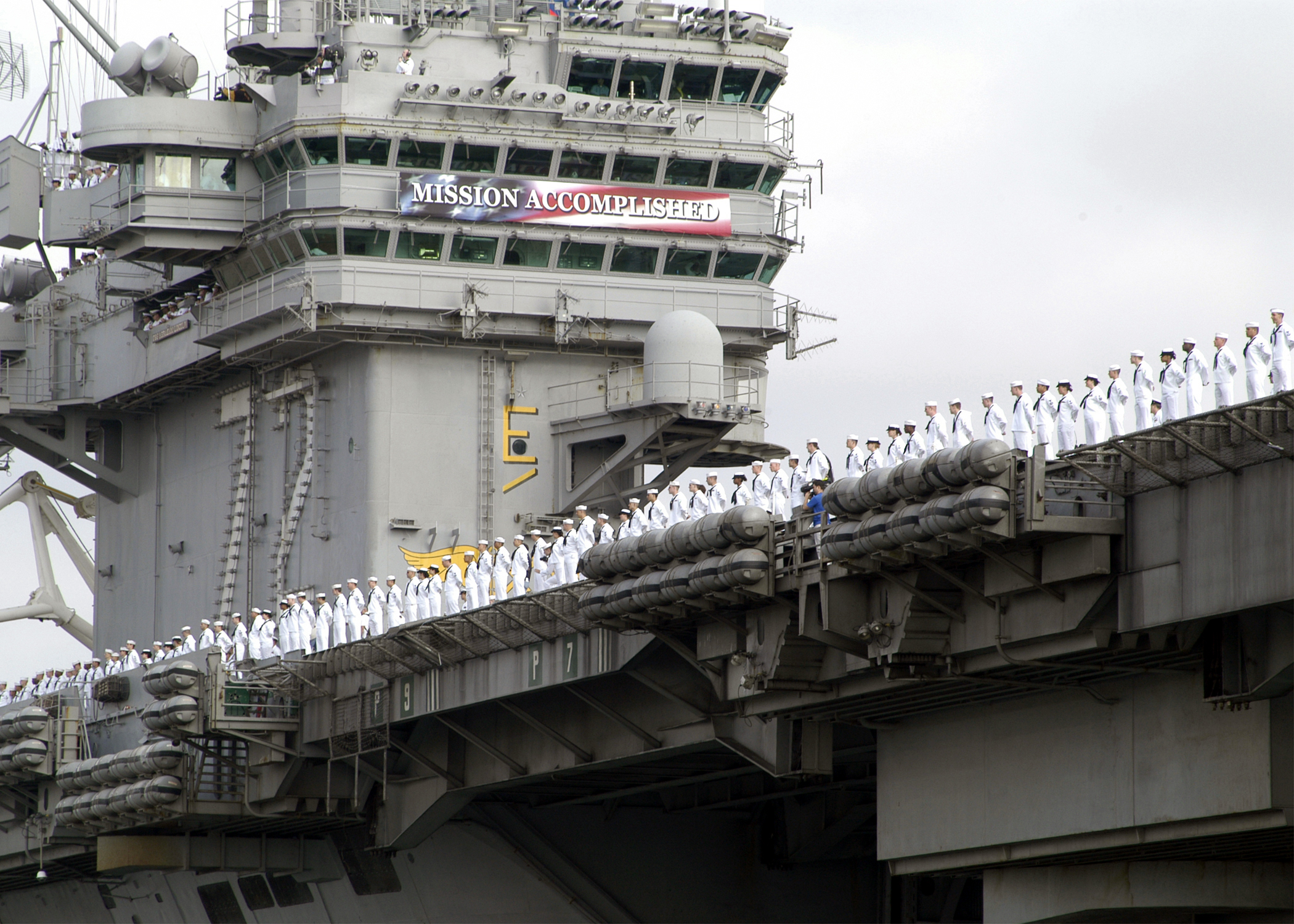 030502-N-9214D-002 Naval Air Station North Island, San Diego, Calif. (May 2, 2003) -- Sailors aboard USS Abraham Lincoln (CVN-72) man the rails as the ship pulls into NAS North Island to a cheering crowd of family and friends during their port visit to off-load the ship’s Air Wing. Lincoln and her embarked Carrier Air Wing Fourteen (CVW-14) are returning from a 10-month deployment to the Arabian Gulf in support of Operation Enduring Freedom and Operation Iraqi Freedom. Operation Iraqi Freedom is the multi-national coalition effort to liberate the Iraqi people, eliminate Iraq’s weapons of mass destruction, and end the regime of Saddam Hussein.