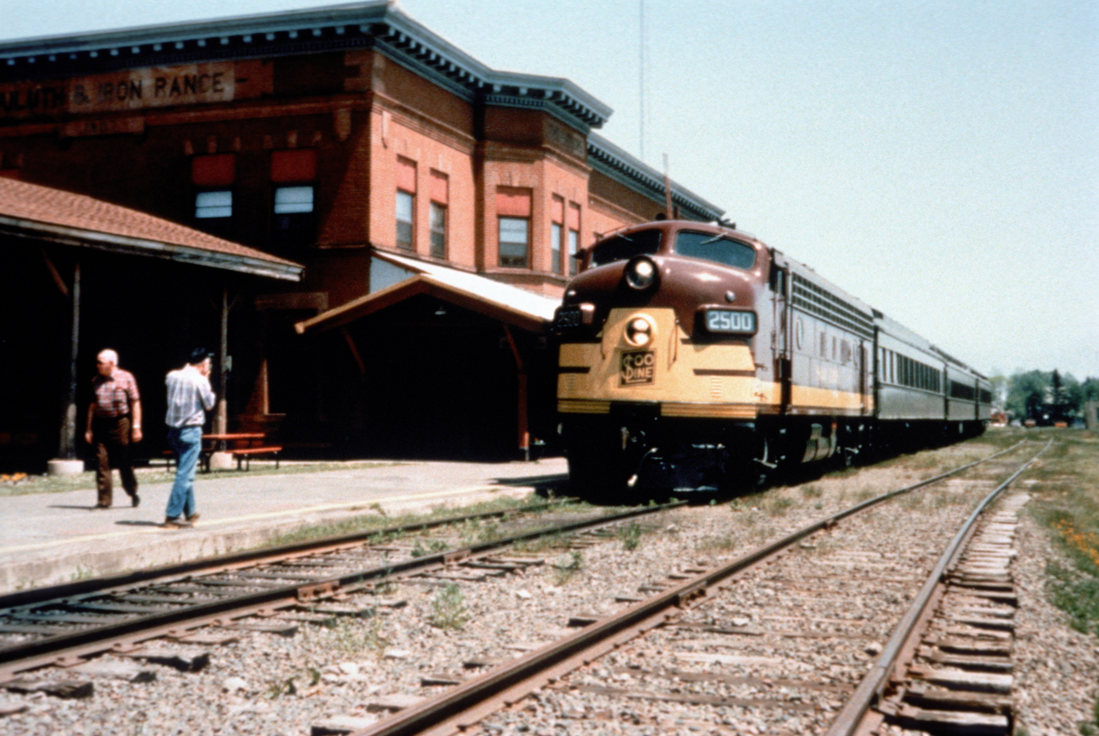 Scope and content:  The original finding aid described this photograph as:
Original Caption: The North Shore Scenic Railroad, running between Duluth and Two Harbors is a popular tourist attraction during the summer and fall seasons. Passengers walk around the historic depot area as they wait to board the train.
Location: Minnesota (47.019° N 91.685° W)

Status: Public domain. Lake County Historical Society