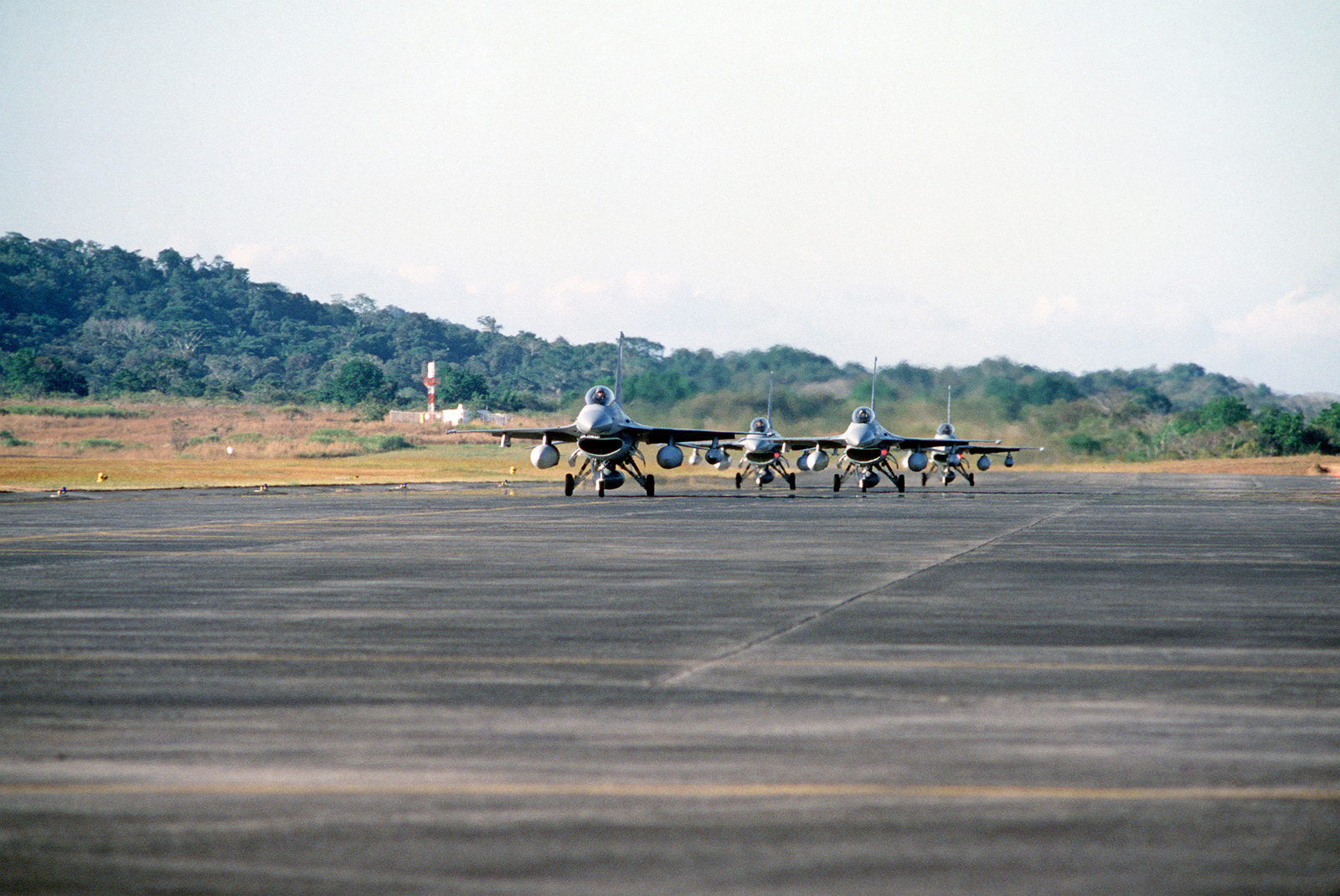 Four USAF F-16 Fighting Falcon aircraft aircraft taxi to the parking apron upon their arrival for Exercise KINDLE LIBERTY 83.