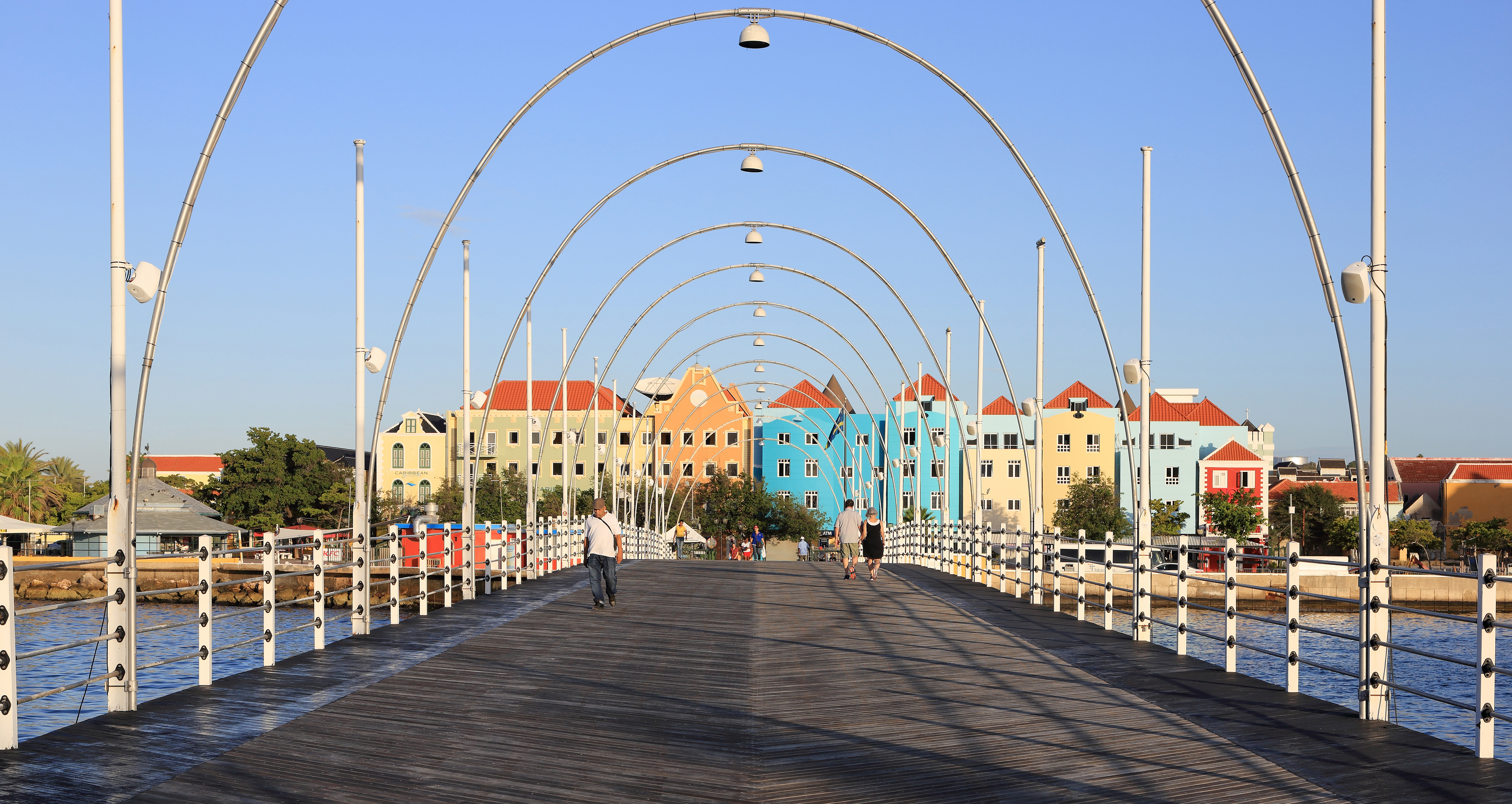 View of the district of Otrobanda, Willemstad, Curaçao, from Queen Emma Bridge, a pontoon bridge across St. Anna Bay. It connects the Punda and Otrobanda quarters of the island's capital. The bridge is hinged and opens regularly to enable the passage of oceangoing vessels.