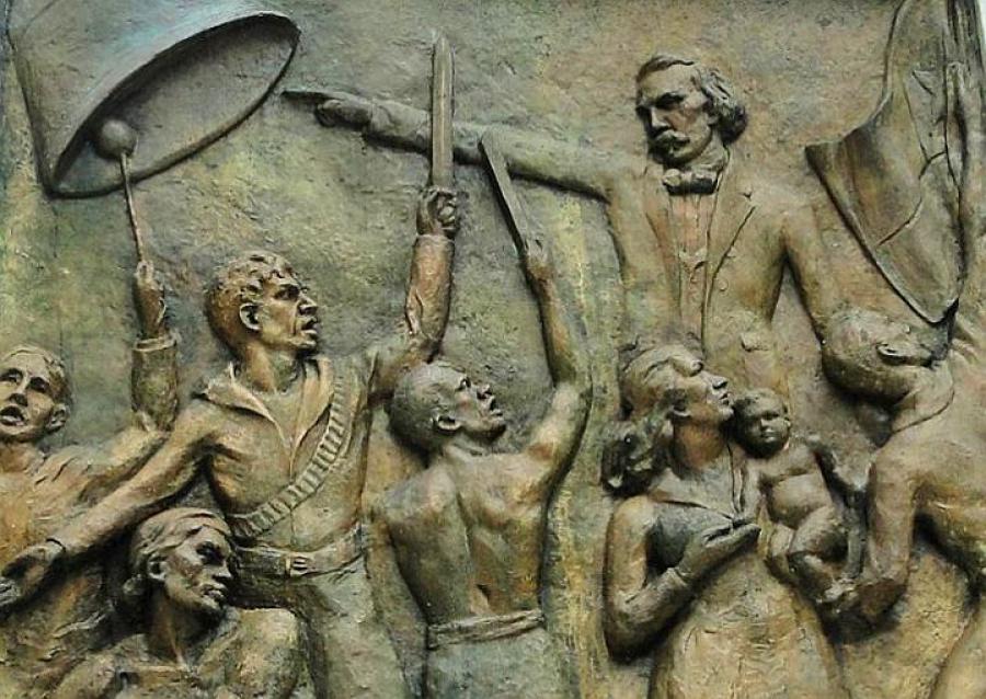 Plaque depicting the Cry of Yara at the base of the monument to Carlos Manuel de Céspedes in Céspedes Park