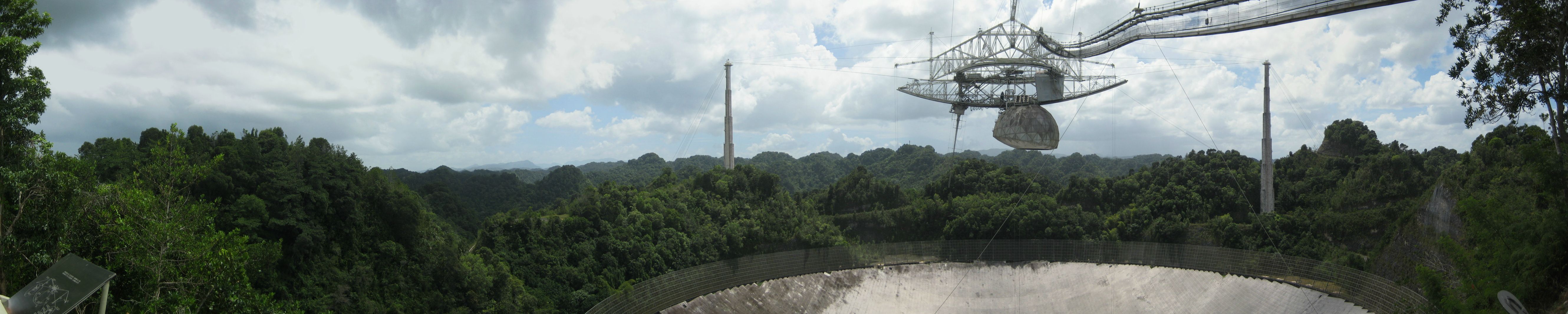 A wide panorama of the Arecibo radio telescope made from the observation deck.