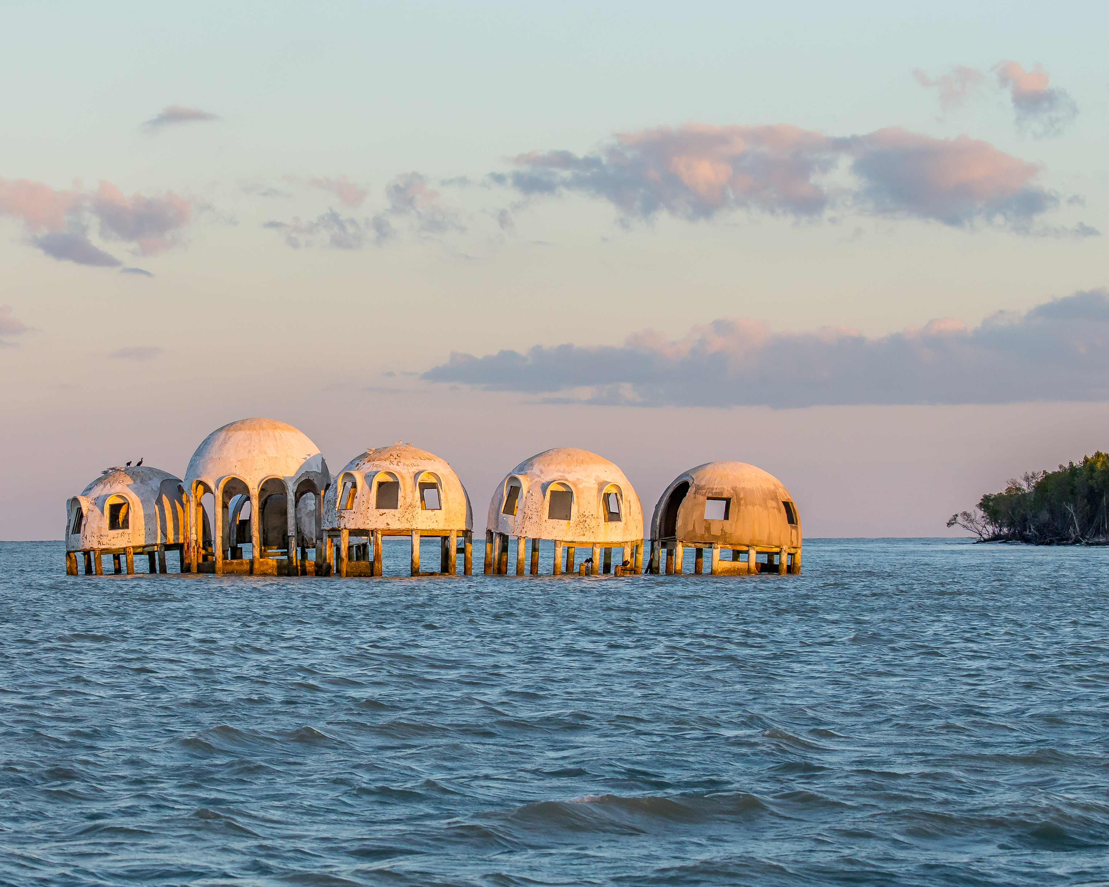 In the 1980s the Cape Romano Dome House was an ultra-modern dwelling built on a beach on an island.  The forces of nature combined to leave the house standing in the sea, slowly falling apart.  This strange sight can be seen near Marco Island, Florida.