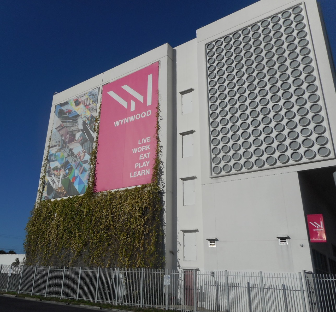 westward view of Wynwood business association banner on at the time tallest building in Wynwood.