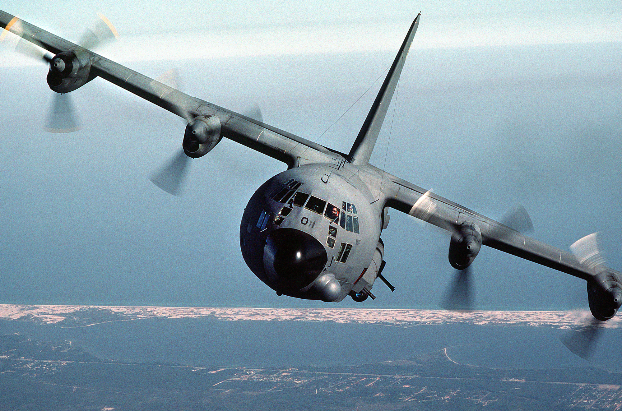 An AC-130A Hercules gunship aircraft performs a pylon turn near Hurlburt Field, Florida during a training mission. The aircraft is from the 919th Special Operations Group, Eglin Air Force Base Auxiliary Field 3 (Duke Field), Florida.