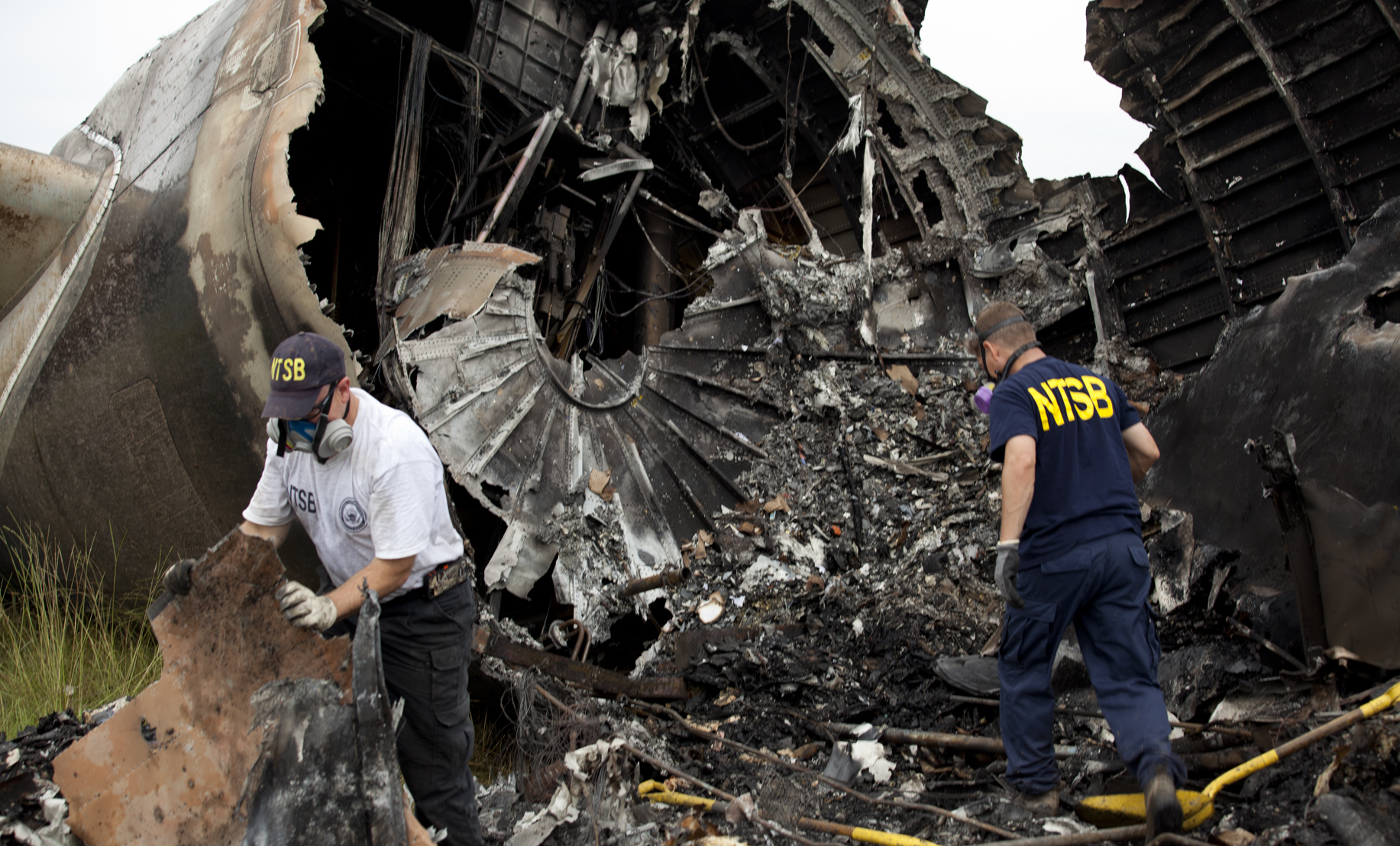 NTSB investigators Clint Crookshanks and Steve Magladry examining wreckage from UPS flight 1354.