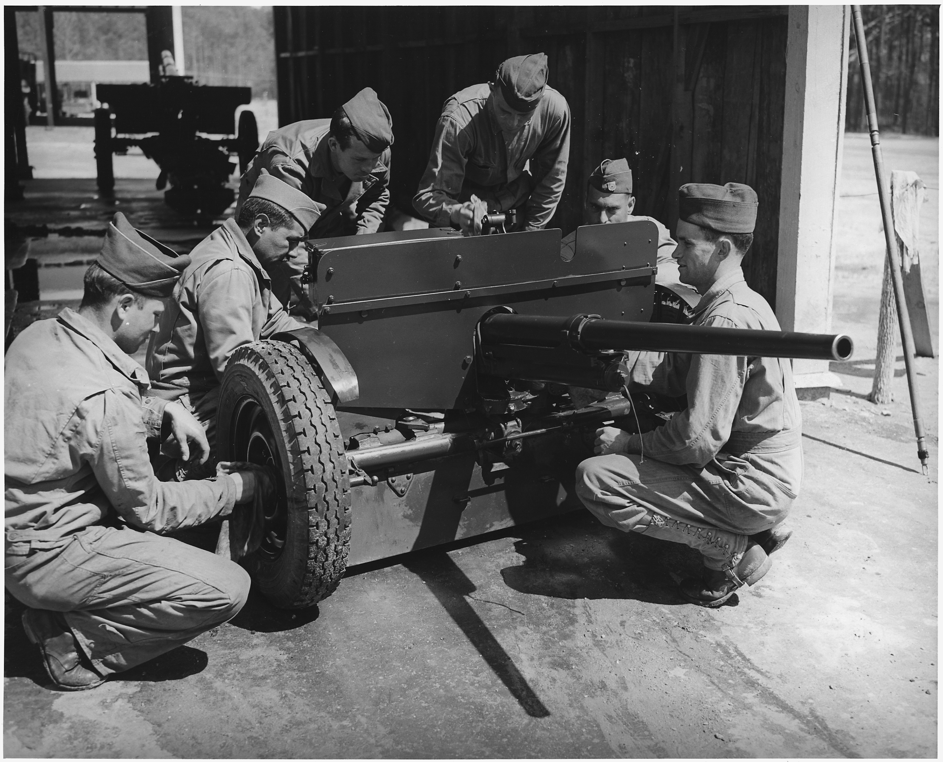 Crew of 37mm. anti-tank gun, in training at Fort Benning, Georgia, clean and adjust their weapon. - NARA - 196275.jpg