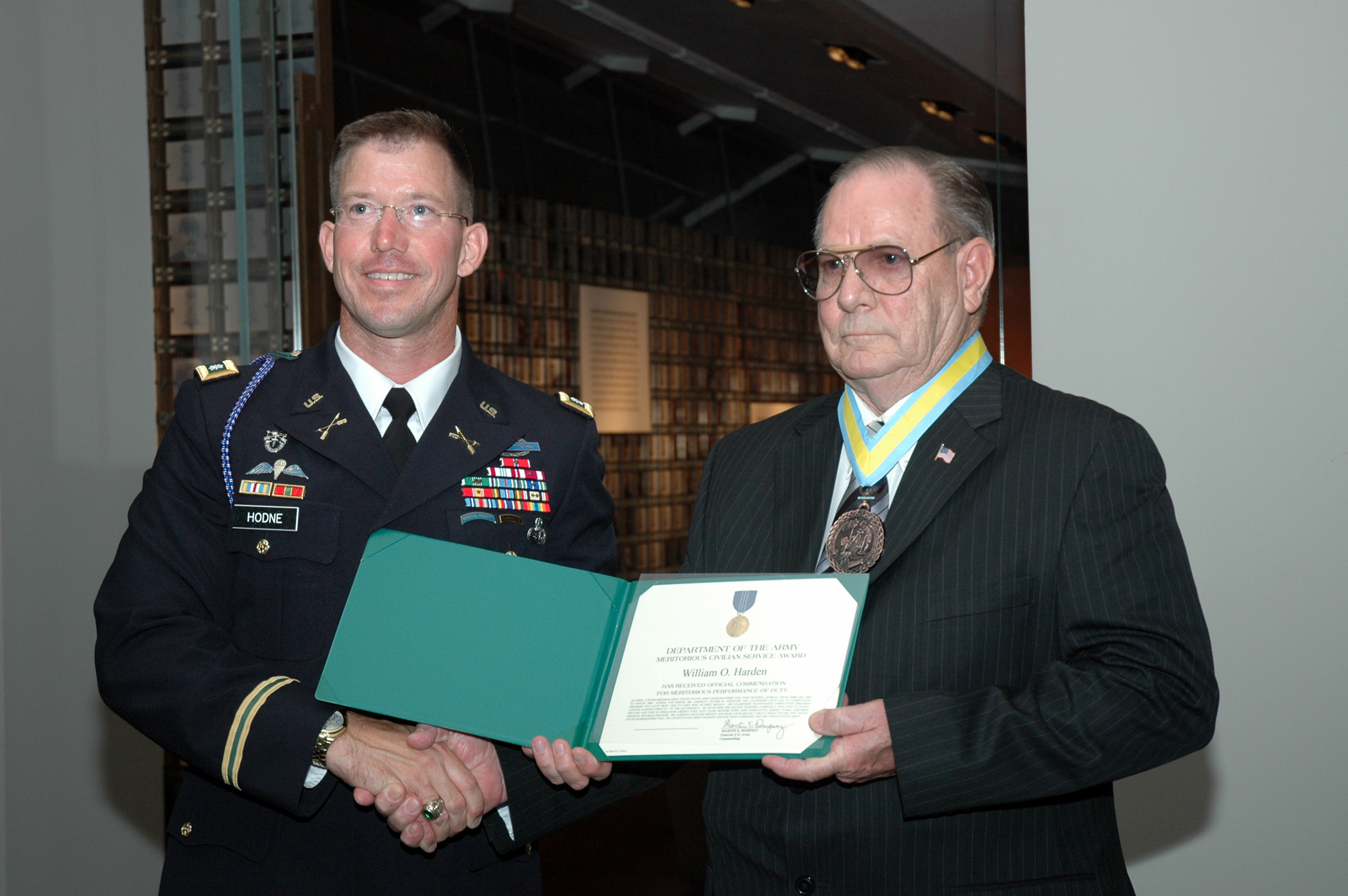 FORT BENNING, Ga.--Lt. Col. Daniel Hodne, commander, U.S. Army Marksmanship Unit, presents William O. Harden with the Meritorious Civilian Service Award Sept. 11 at the National Infantry Museum. Harden was honored by the Soldiers and civilians of the USAMU along with numerous guests for his 52 years of service to the country.
(Photo by Ray Arredondo)