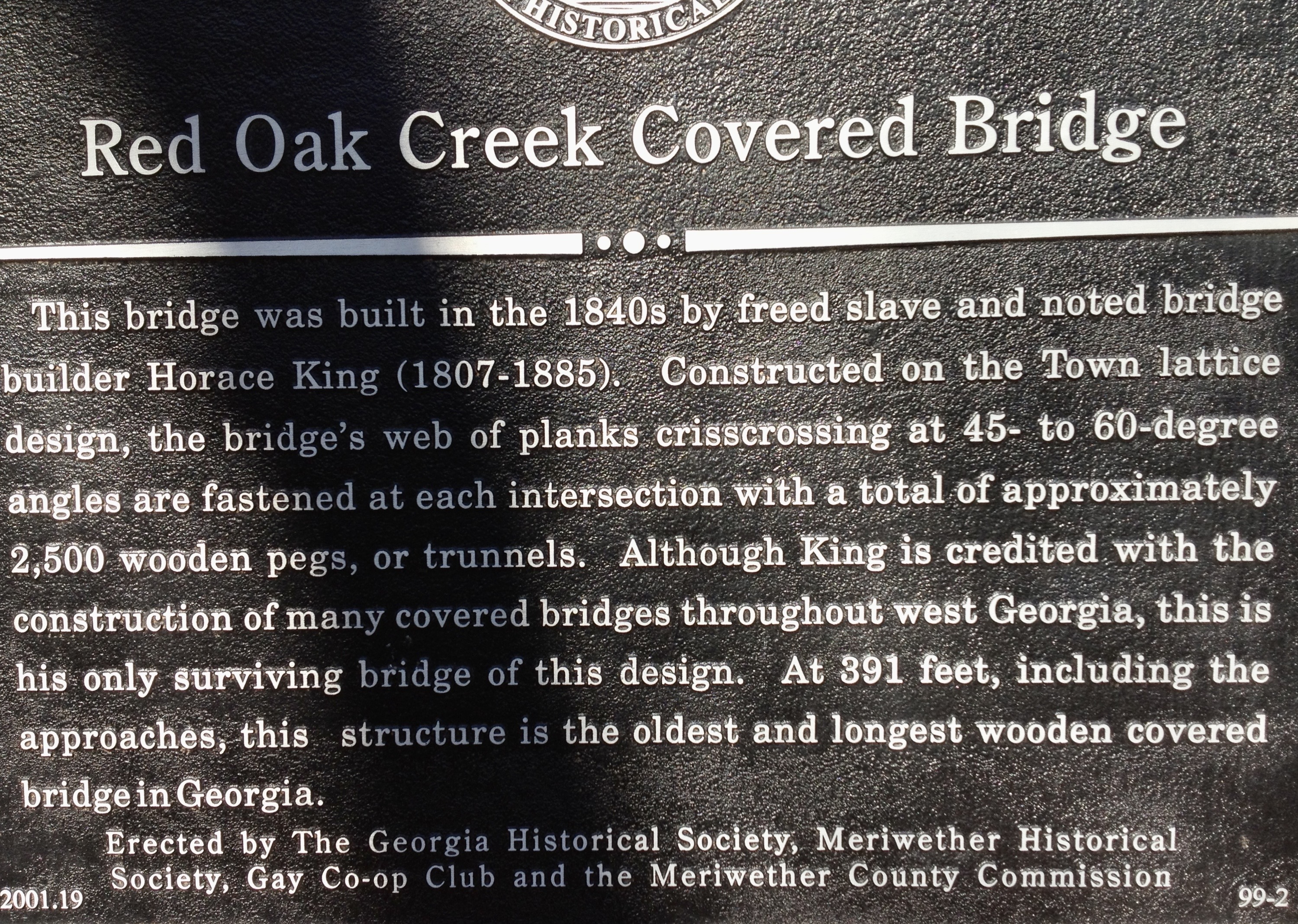 This is the historical marker for the Red Oak Covered Bridge in Meriwether County, Georgia erected by The Georgia Historical Society, Meriwether Historical Society, Gay Co-op Club and the Meriwether County Commission