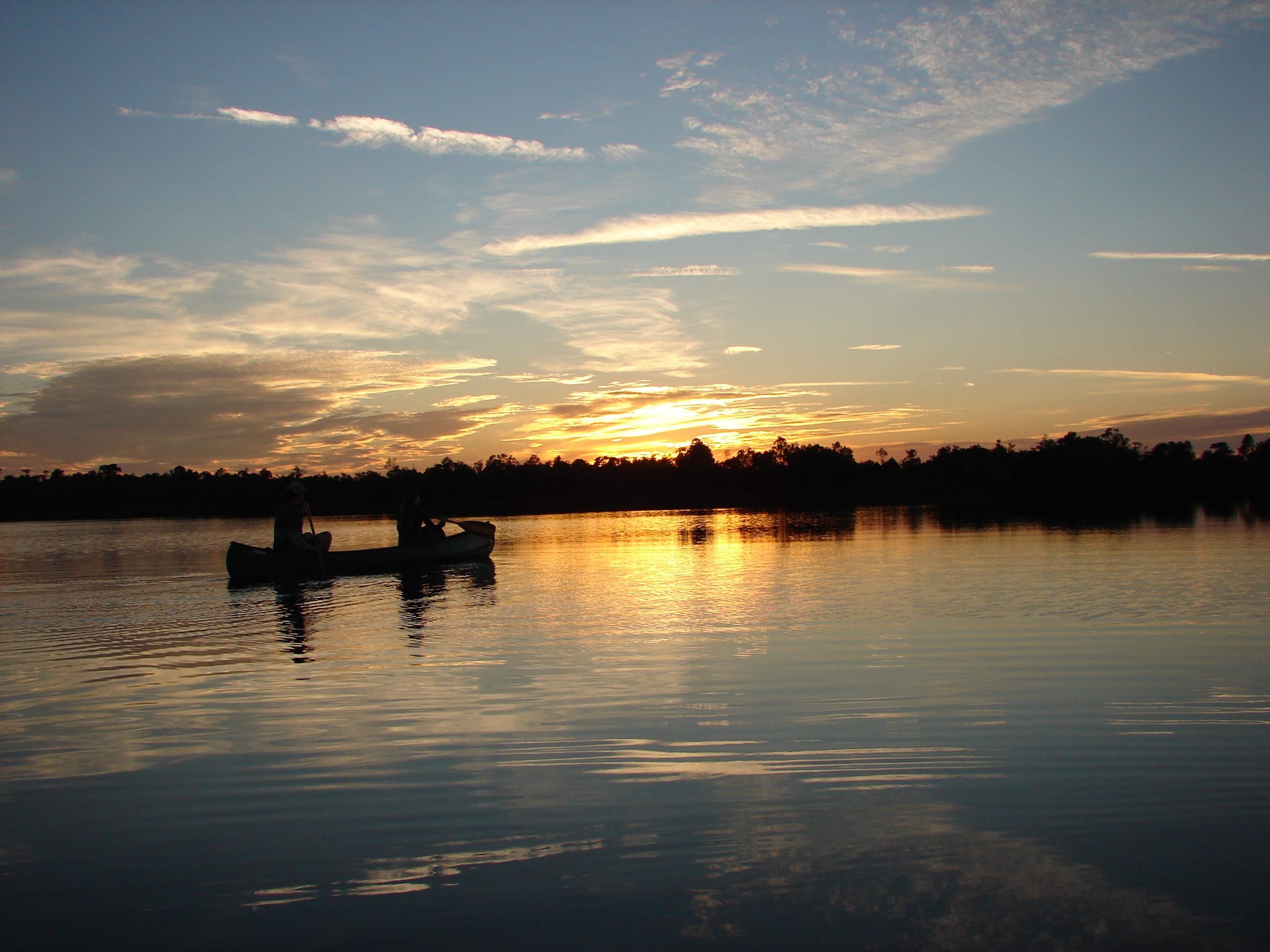 Canoeists watching sunset in Chesser Prairie, Okefenokee National Wildlife Refuge, GA. Joy CampbellOkefenokee Adventures