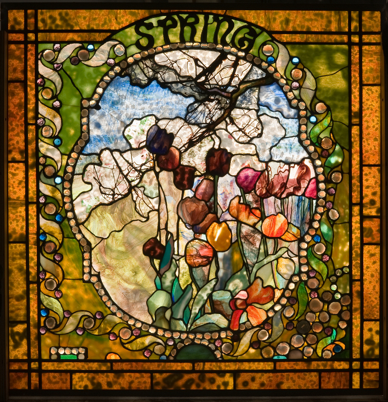One of four leaded-glass panels featuring a seasonal theme designed by Louis Comfort Tiffany. This panel was on display at Tiffany's Long Island estate Laurelton Hall, and is now in the permanent collection of the Charles Hosmer Morse Museum of American Art.