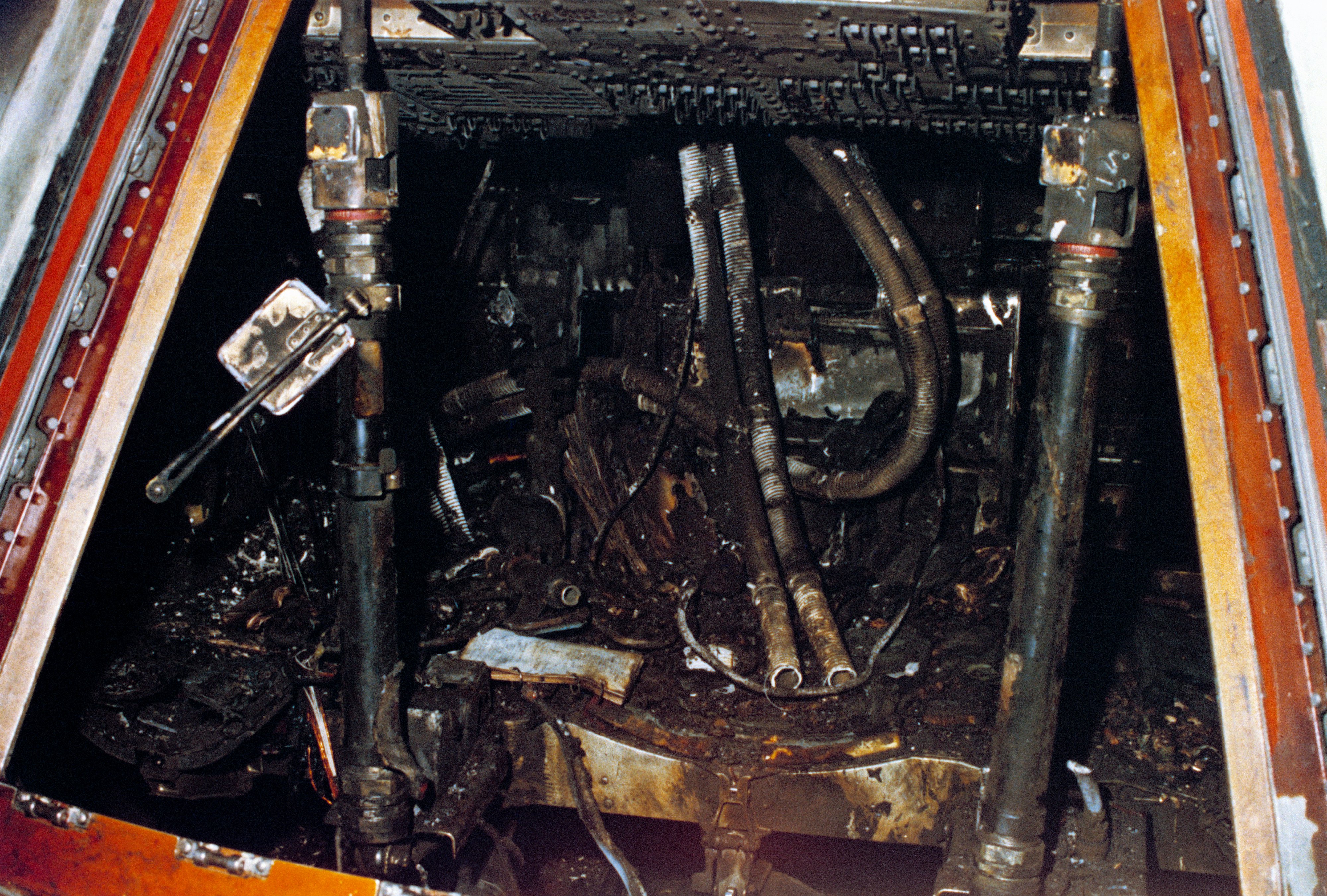Officially designated Apollo/Saturn 204, but more commonly known as Apollo 1, this close-up view of the interior of the Command Module shows the effects of the intense heat of the flash fire which killed the prime crew during a routine training exercise.
While strapped into their seats inside the Command Module atop the giant Saturn rocket, a wire bundle that was worn due to misplacement and a sharp-edged access door, sparked and ignited flammable material. This quickly grew into a large fire in the pure oxygen environment. The speed and intensity of the fire quickly exhausted the oxygen supply inside the crew cabin. Unable to deploy the hatch due to its cumbersome design and lack of breathable oxygen, the crew lost consciousness and perished. They were: astronauts Virgil I. "Gus" Grissom, (the second American to fly into space) Edward H. White II, (the first American to "walk" in space) and Roger B. Chaffee, (a "rookie" on his first space mission).