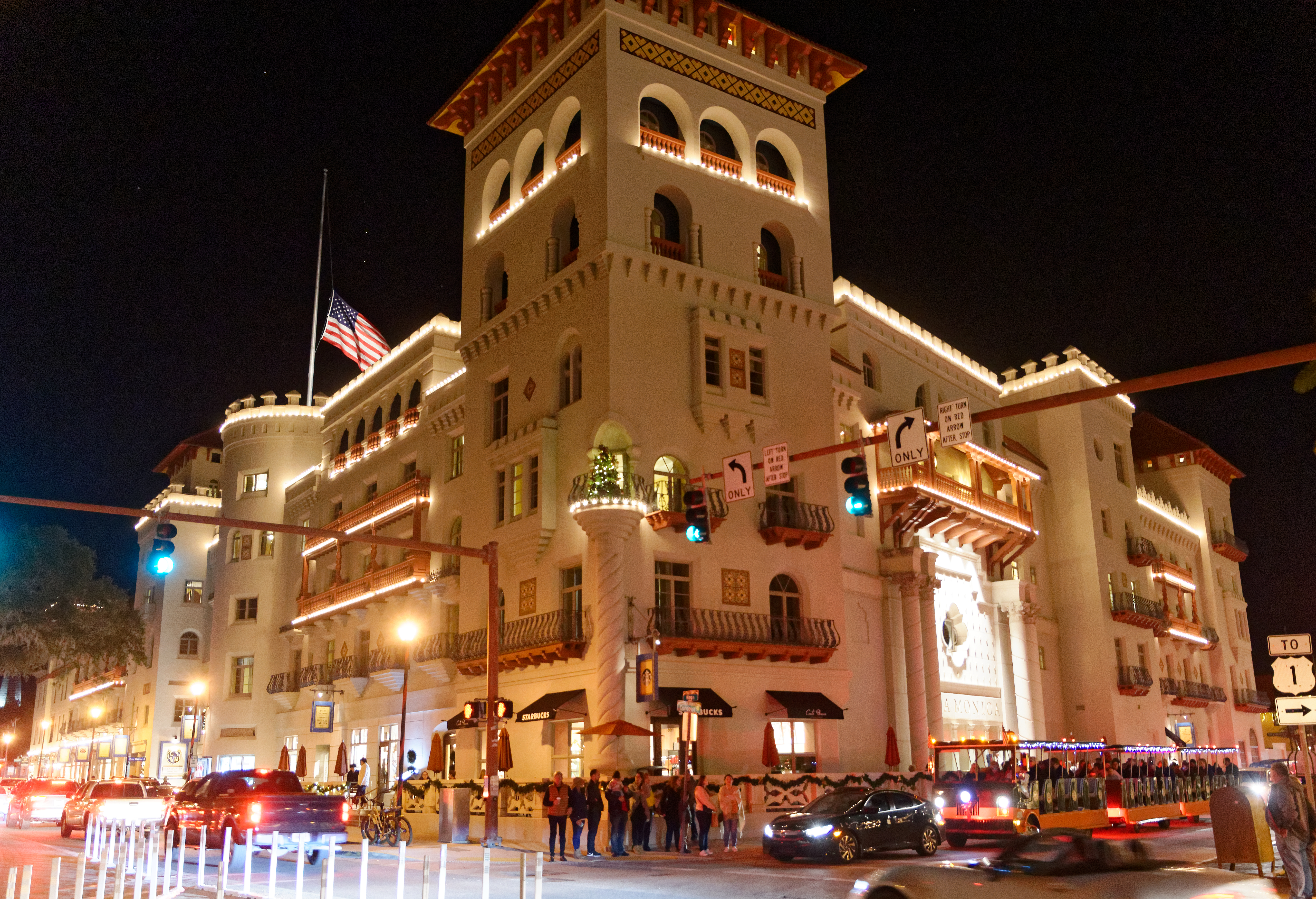 The Casa Monica Hotel at night. In St. Augustine, Florida, US. The stars of the constellation Orion are behind the flagpole. The stars of the belt run vertically to the right of the flagpole.
