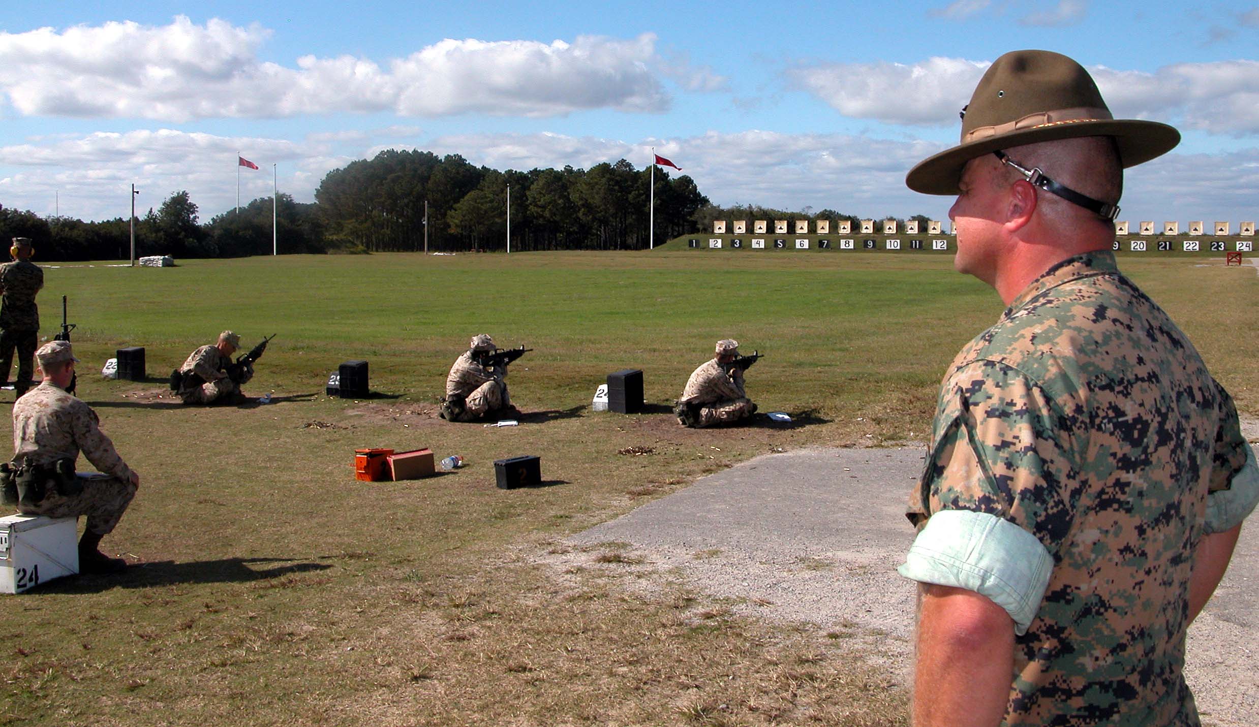 Caption: "Every Marine's a rifleman," Chief Warrant Officer Timothy Soignet remarked November 2 amid the pop and crack of scores of M16 rifles rifles firing at Chosin Range at Marine Corps Recruit Depot Parris Island, South Carolina.