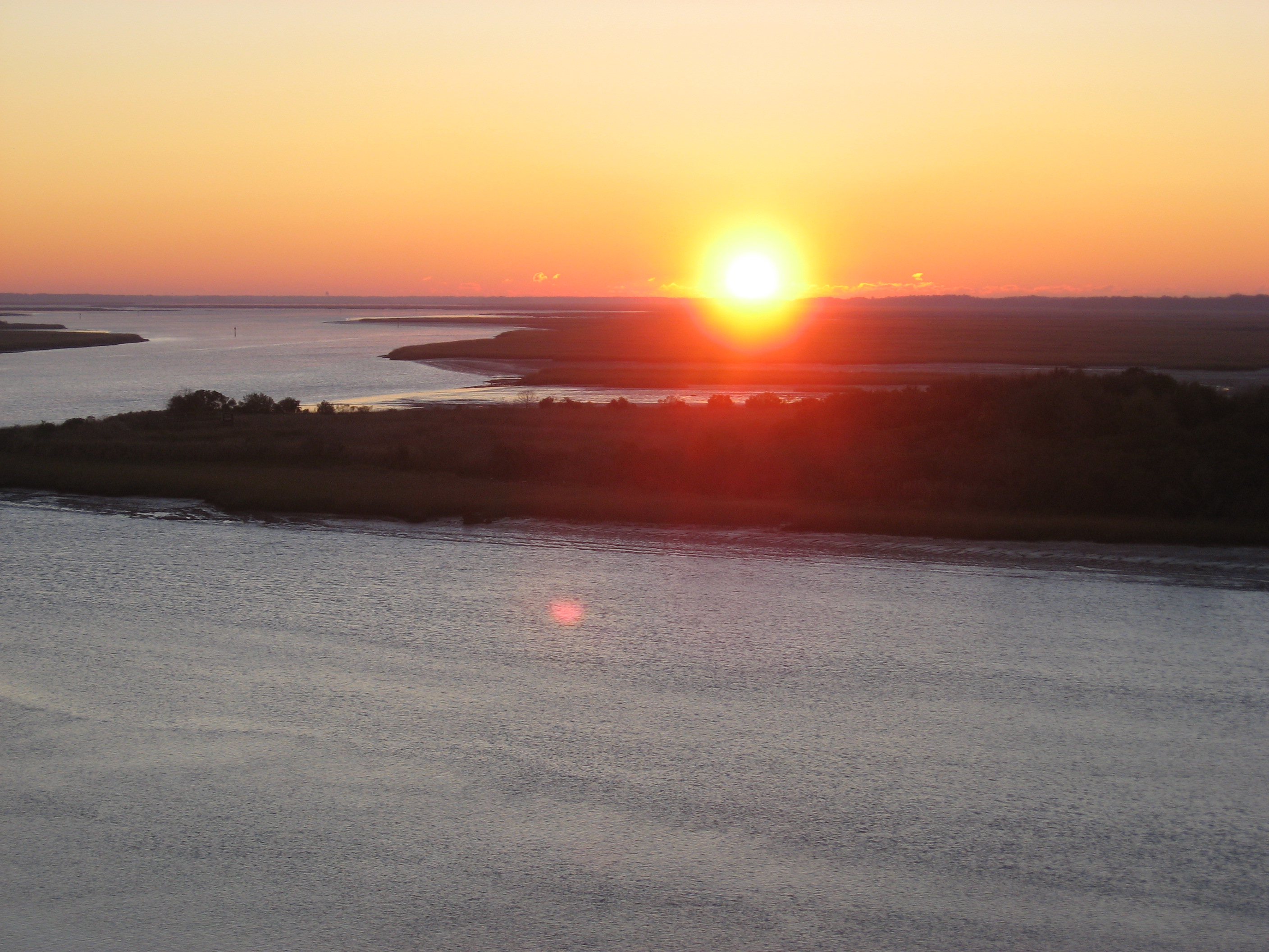 Scope and content:  The original finding aid described this photograph as:
Original Caption: The sun rises casting orange, red, and pink light across the Intracoastal Waterway along the Edisto Island National Scenic Byway.
Location: South Carolina (32.599° N 80.346° W)

Status: Public domain.