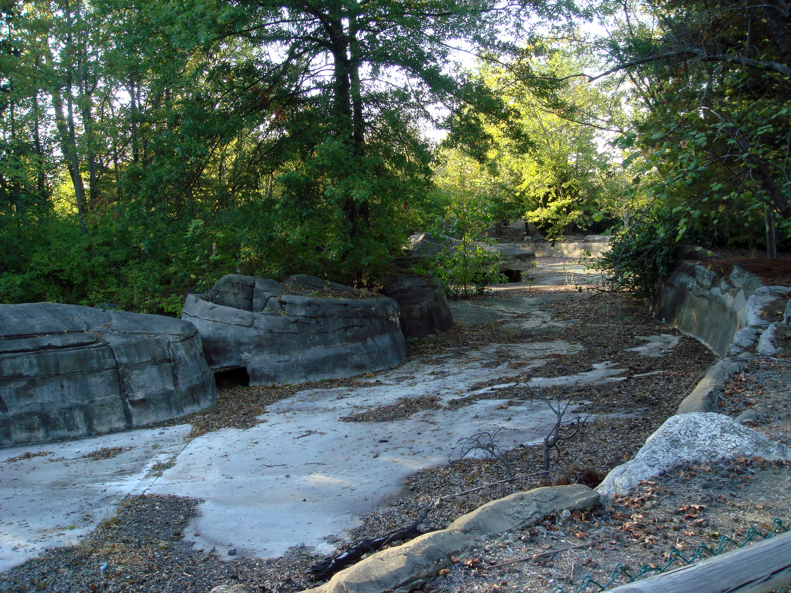 The leftover ruins of the defunct Opryland USA (in Nashville, Tennessee), which took its name from the Grand Ole Opry music venue (which was originally located in downtown Nashville but moved next door to the new theme park in the 1970s).  What is now the enormous Gaylord Opryland Resort &amp; Convention Center opened soon afterwards and began expanding into the empty land near the park, curtailing expansion.  The theme park closed at the end of 1997, and was mostly demolished to make room for the Opry Mills shopping center.  Only a tiny portion of the old park remains, this is a photo of the former Grizzly River Rampage.  These sections will be demolished for the next Opryland hotel expansion.