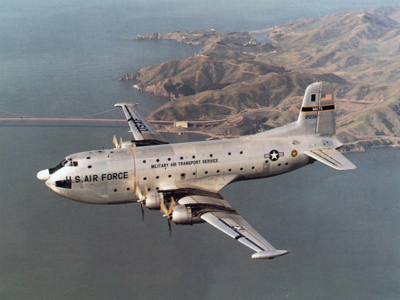 A U.S. Air Force Douglas C-124C Globemaster II (s/n 52-1035) in flight.
Golden Gate Bridge and Marin County, CA in background.

Original caption: "The Douglas C-124C Globemaster II was an airlift workhorse well into the Vietnam War."