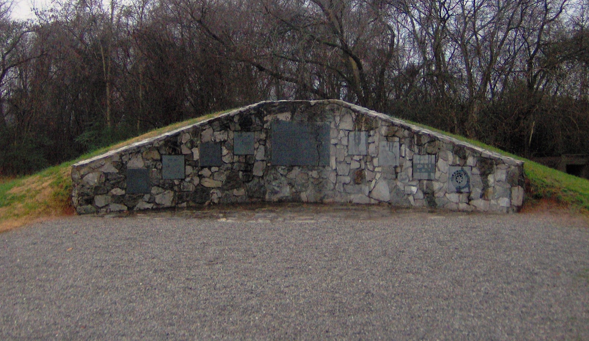 Burial mound at the Sequoyah Museum in Vonore, Tennessee, in the southeastern United States.  The mound contains 191 burials that were excavated in the Tellico Archaeological Project, 1969-1979.  The burials were reinterred here in the Spring of 1986.  The right half of the center plaque displays Timberlake's "Draught of the Cherokee Country"; the left half reads:


A PRINCIPAL PEOPLE
IN MEMORY OF THE CHEROKEE PEOPLE
WHO LIVED IN THE LITTLE TENNESSEE
VALLEY PRIOR TO THE INUNDATION
OF THE TELLICO RESERVOIR IN 1979.
ARCHAEOLOGICAL INVESTIGATIONS
WERE CONDUCTED AT THE MAJOR
18TH CENTURY CHEROKEE SITES.  THE
REMAINS OF 191 INDIVIDUALS
RECOVERED IN THOSE EXCAVATIONS

ARE BURIED IN THIS MOUND.